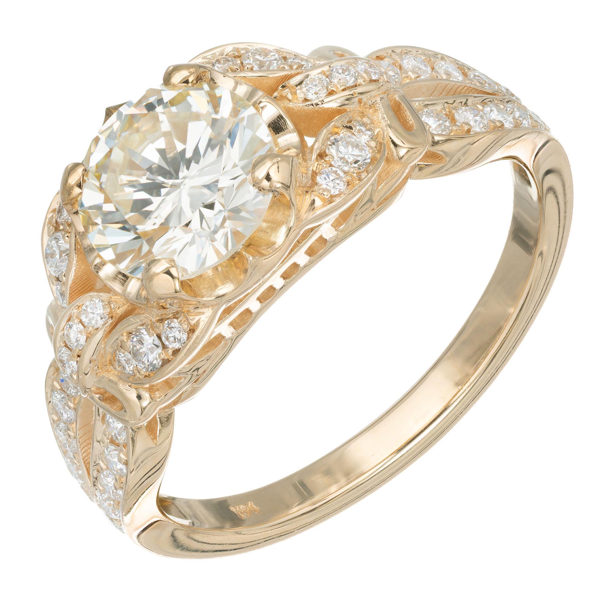 Peter Suchy Antique inspired diamond engagement ring. GIA certified round center stone with butterfly design sides and pave diamonds set in a 14k yellow gold setting.  

1 round brilliant cut diamond M SI, approx.  1.21ct GIA Certificate #
