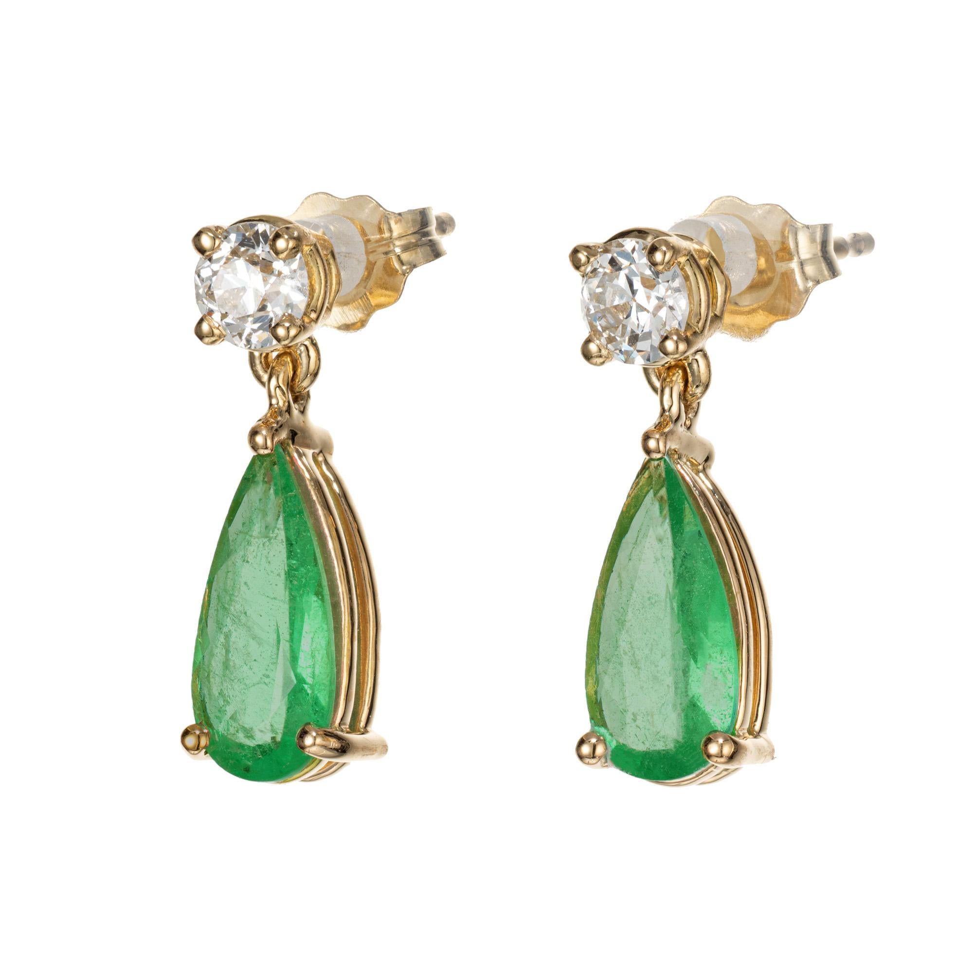 GIA certified emerald diamond dangle earrings. GIA certified pear shaped green emeralds, each with one round diamond above them. Designed and crafted in the Peter Suchy Workshop.

2 pear shape green emeralds, MI approx. 1.21cts GIA certificate #
