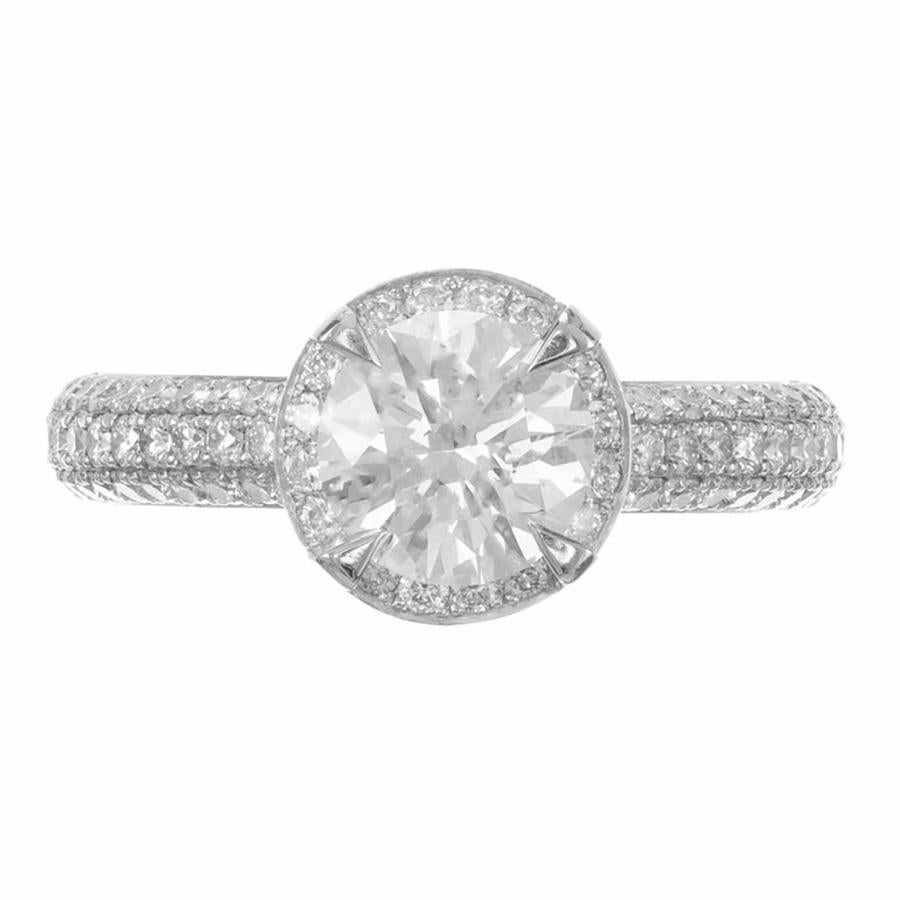 Beautiful Diamond halo engagement ring. This GIA certified round ideal cut center diamond is mounted in a platinum setting with with a halo of ideal cut diamonds. Each shoulder is adorned with two rows of ideal cut diamonds that go half way down