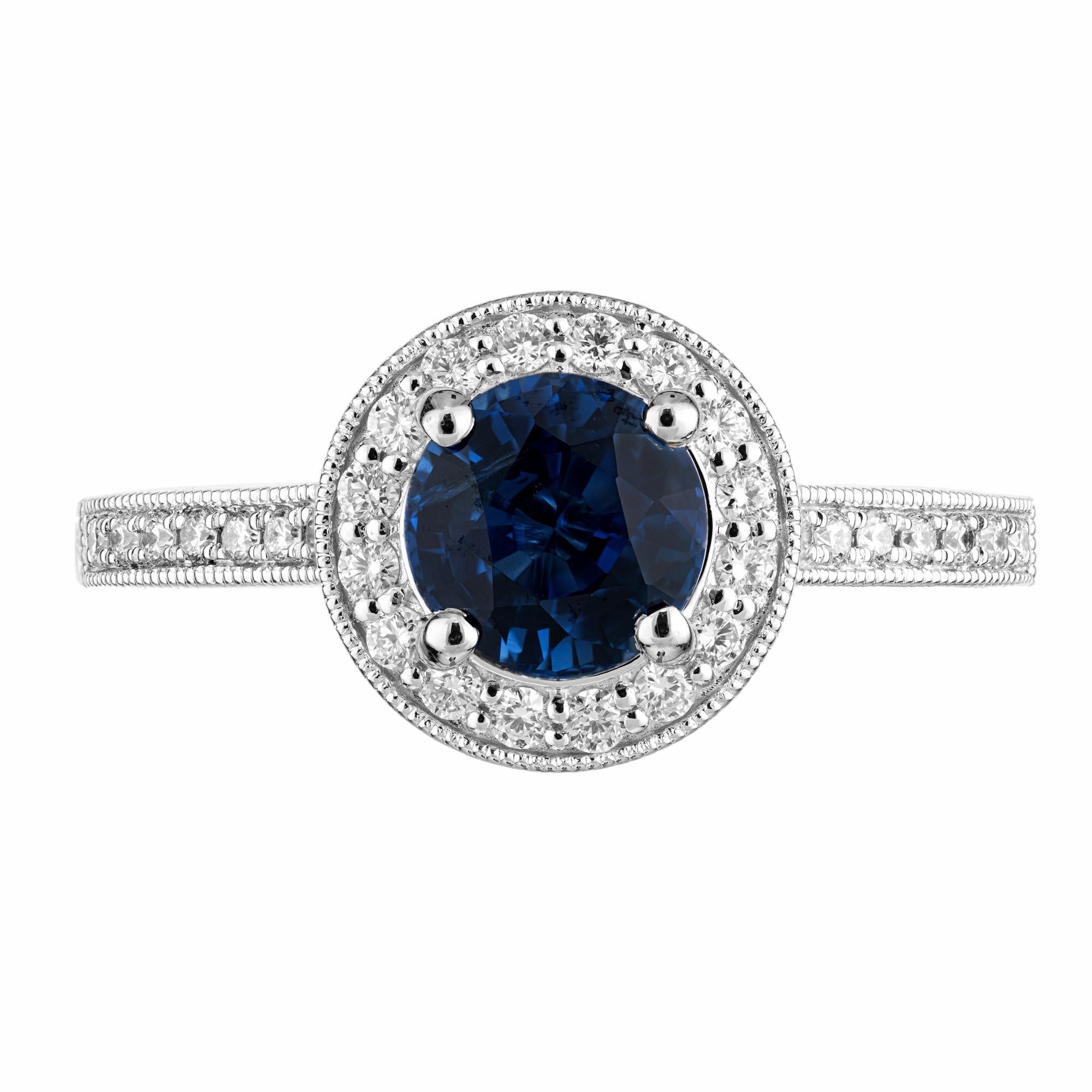 Sapphire Diamond Gold Halo Engagement Ring. The centerpiece is a 1.22 carat round sapphire certified by GIA as simple heat, accented by a halo of round brilliant cut diamonds. The shoulders of the 14k white gold setting is also adorned with round