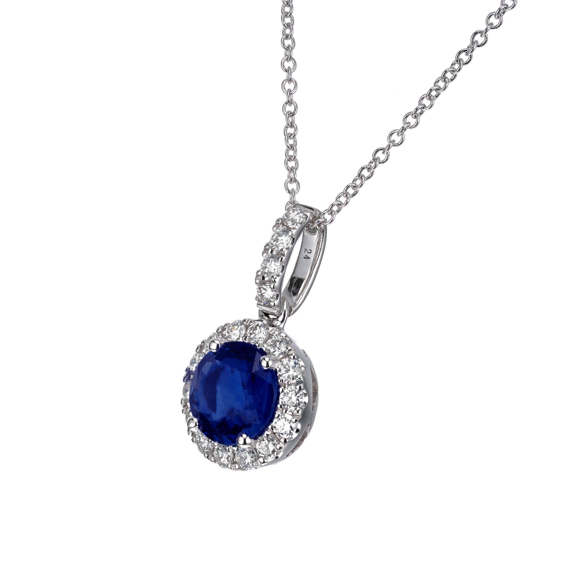 1.30 carat round Ceylon sapphire diamond halo pendant necklace. GIA certified round center sapphire with a halo of 18 diamonds. Set in 18k white gold. Crafted in the Peter Suchy Workshop.

1 round blue sapphire SI, approx. 1.30ct GIA Certificate #