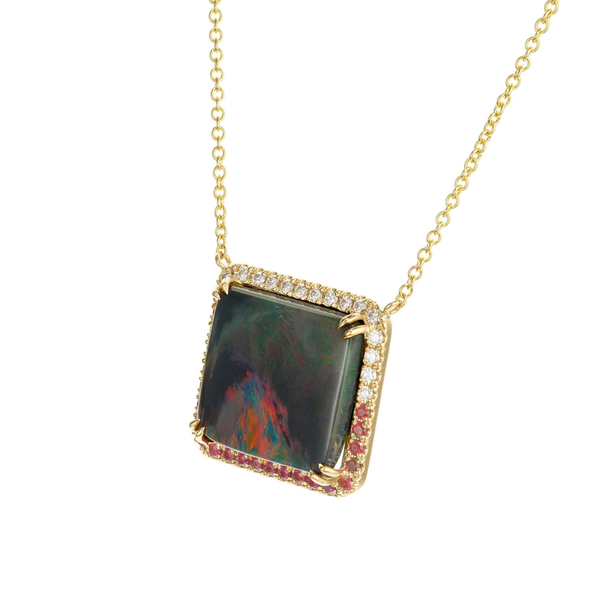 Opal, diamond and ruby pendant necklace. GIA certified 13.74cts square opal with a halo of 19 round diamonds and 19 round rubies set in 18k yellow gold. 18 inch chain. The background color of the opal is gray with red and green flashes. Designed and