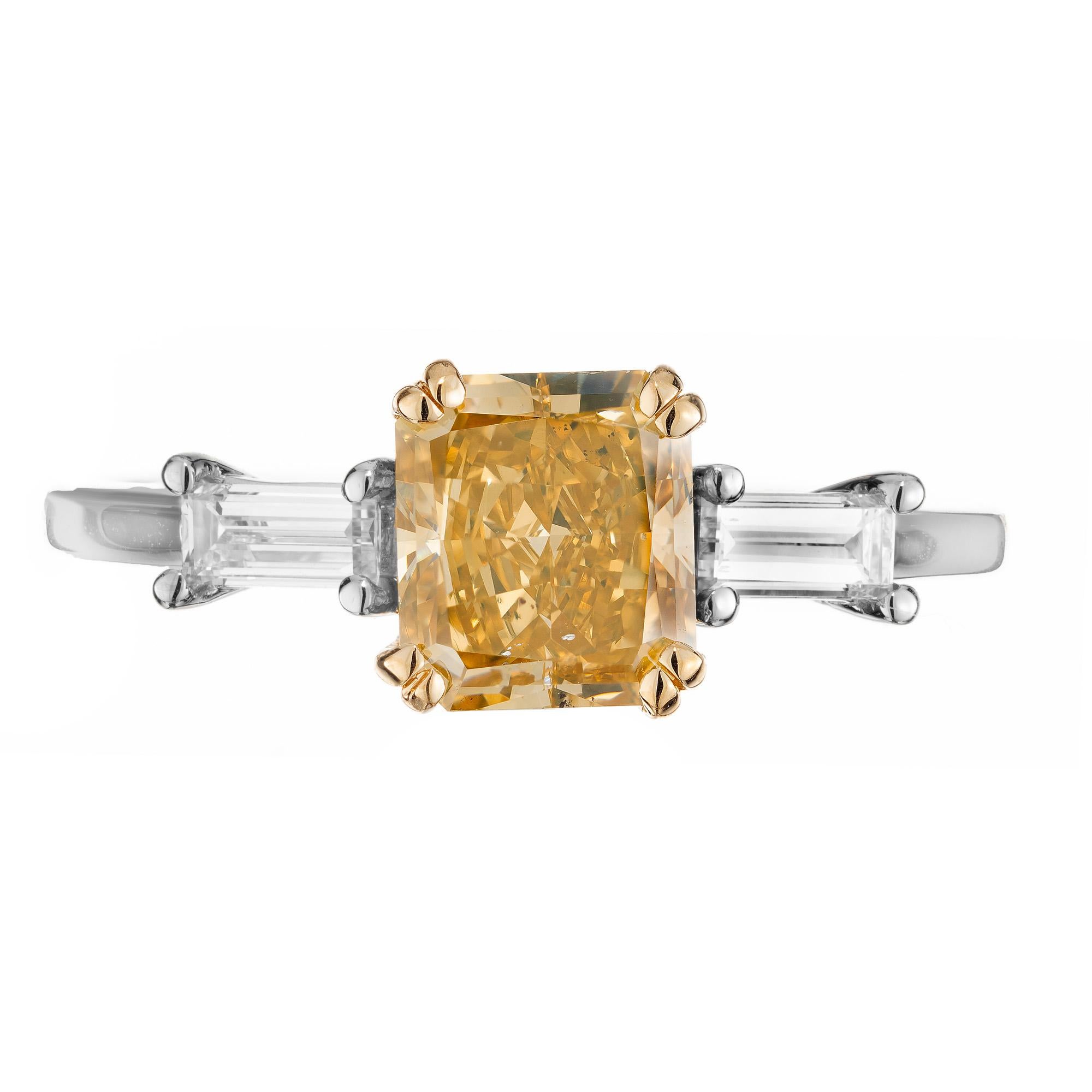 Gorgeous 1.42 carat natural GIA certified radiant cornered cut diamond engagement ring. At the center of this three-stone setting is a brownish yellow rectangular cut 1.42ct diamond. Beautifully accented by 2 straight cut baguette diamonds. Deep and