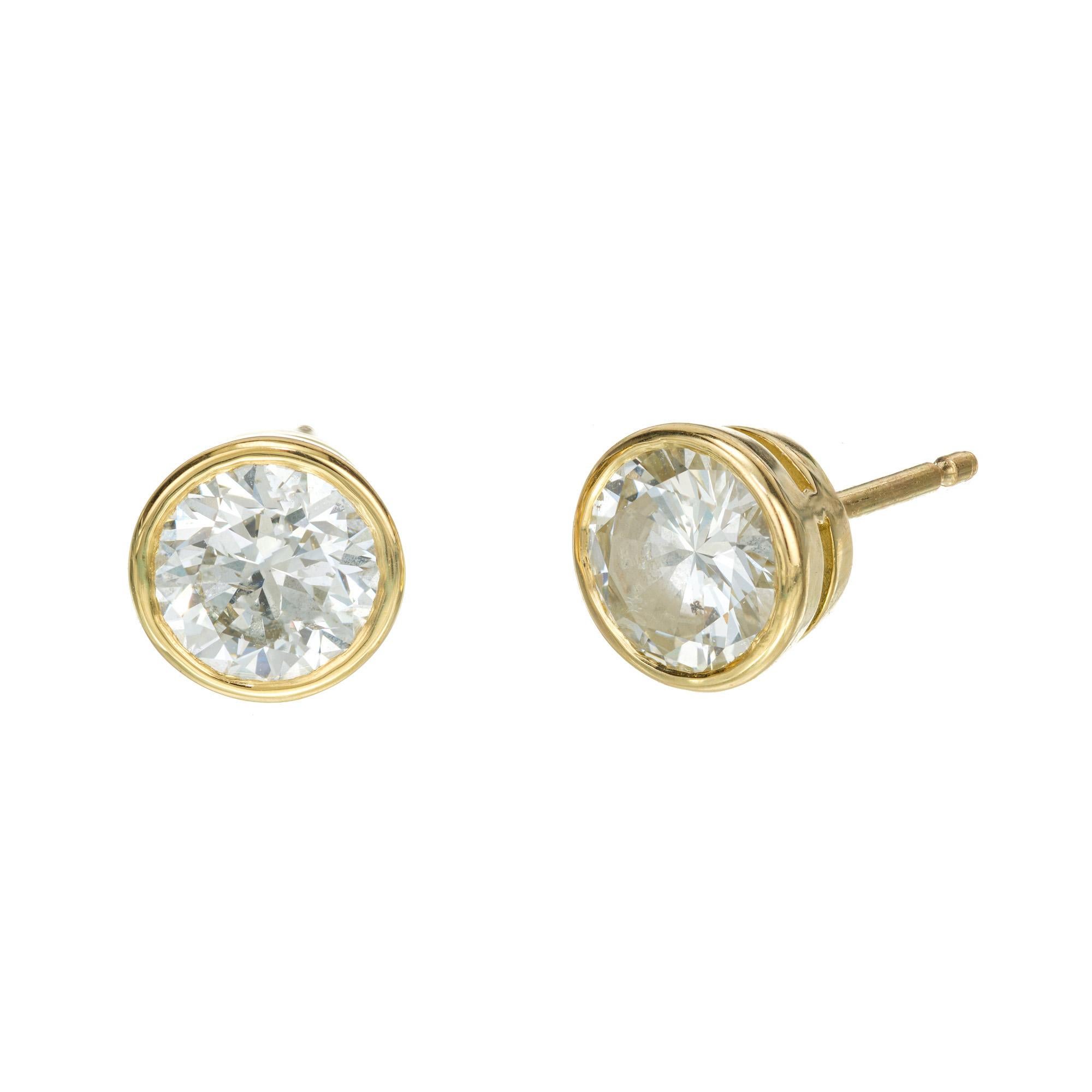 Well matched pair of transitional cut diamond stud earrings. 2 GIA certified 1.50ct bezel set round brilliant cut diamonds. The diamonds are from the 1940's set in 18k yellow gold bezel settings. Designed and crafted in the Peter Suchy workshop. 

1