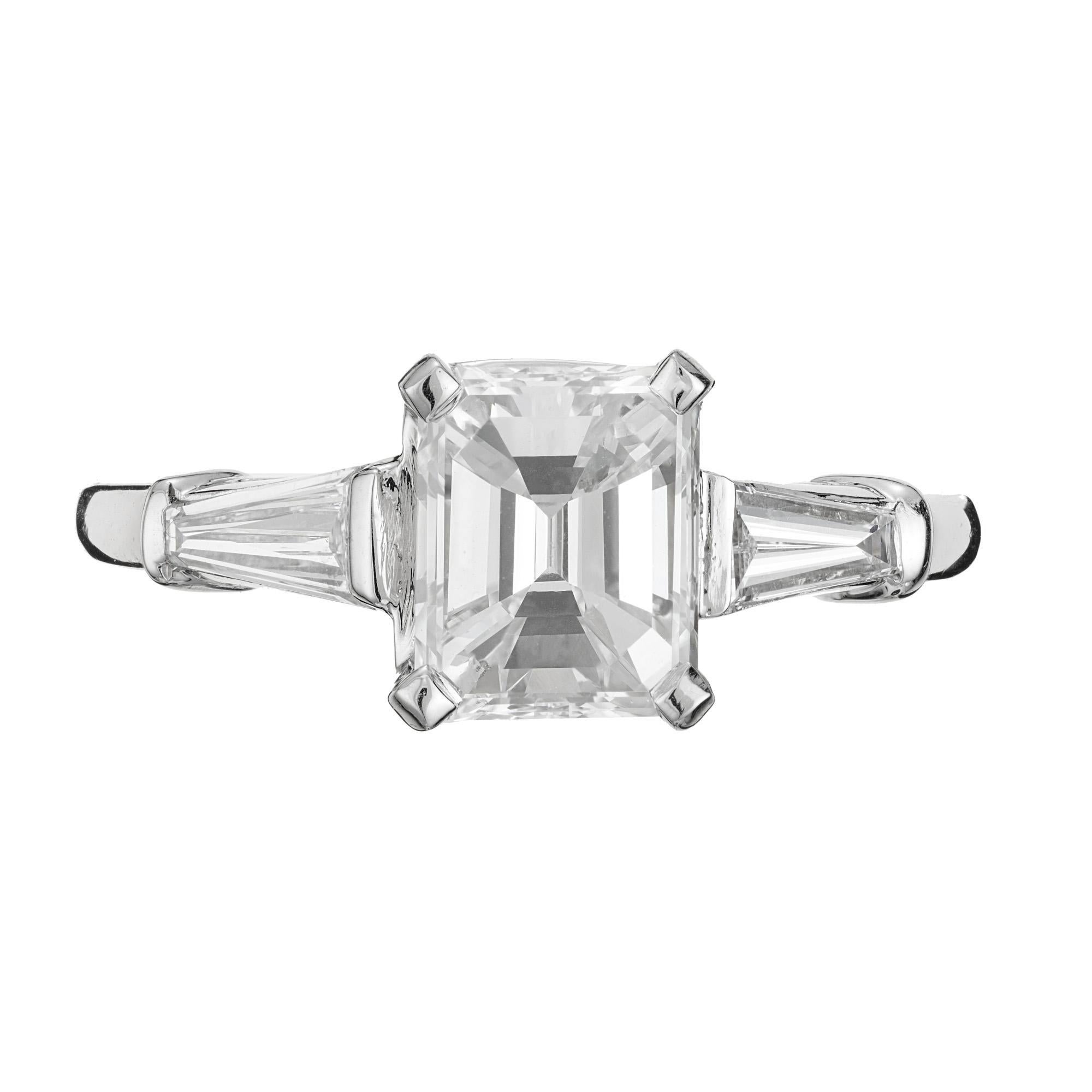 Emerald step and baguette cut diamond ring. GIA certified emerald cut center diamond set in a platinum three-stone engagement setting with two tapered baguette side diamonds. The center diamond is from a 1920's ring with excellent sparkle and a