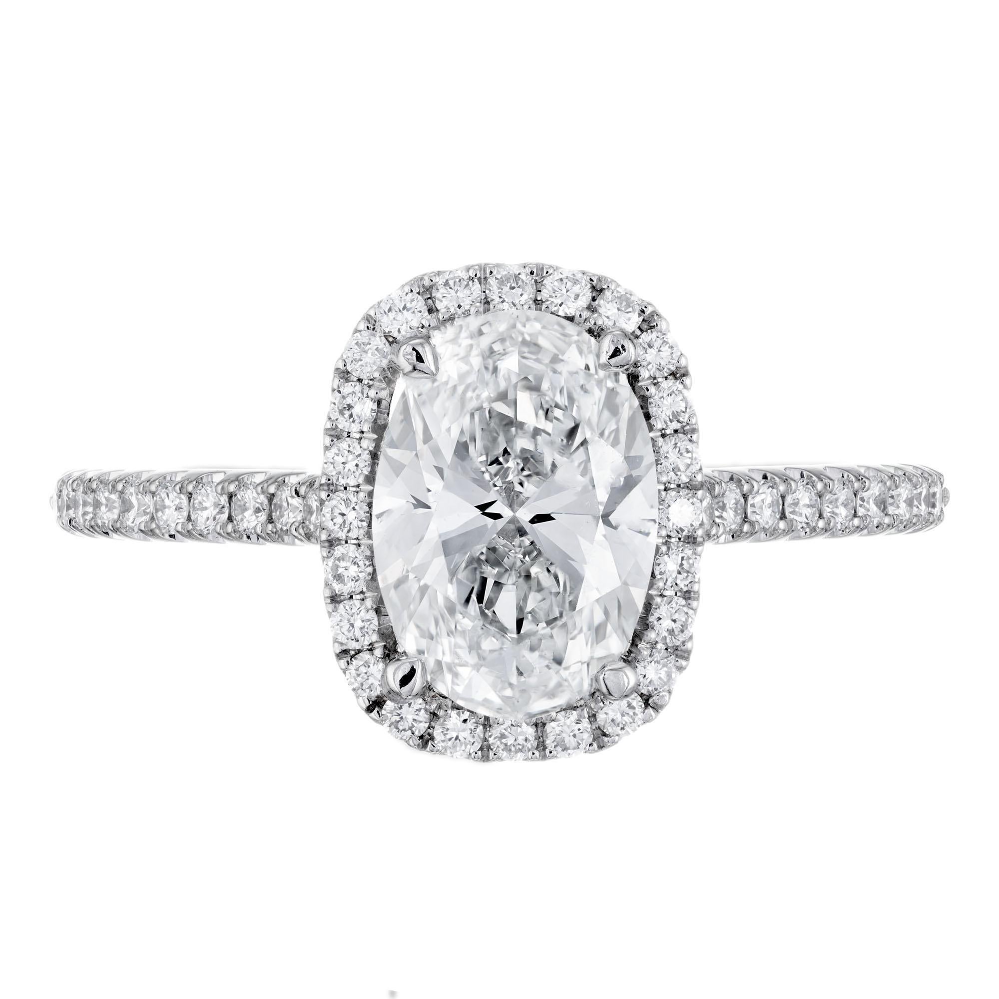 Oval diamond engagement ring. GIA Certified oval center stone with a halo of round diamonds in a platinum setting. Created in the Peter Suchy Workshop. 

1 oval brilliant cut diamond H, VS, approx. 1.51cts GIA Certificate # 2191689944
46 round