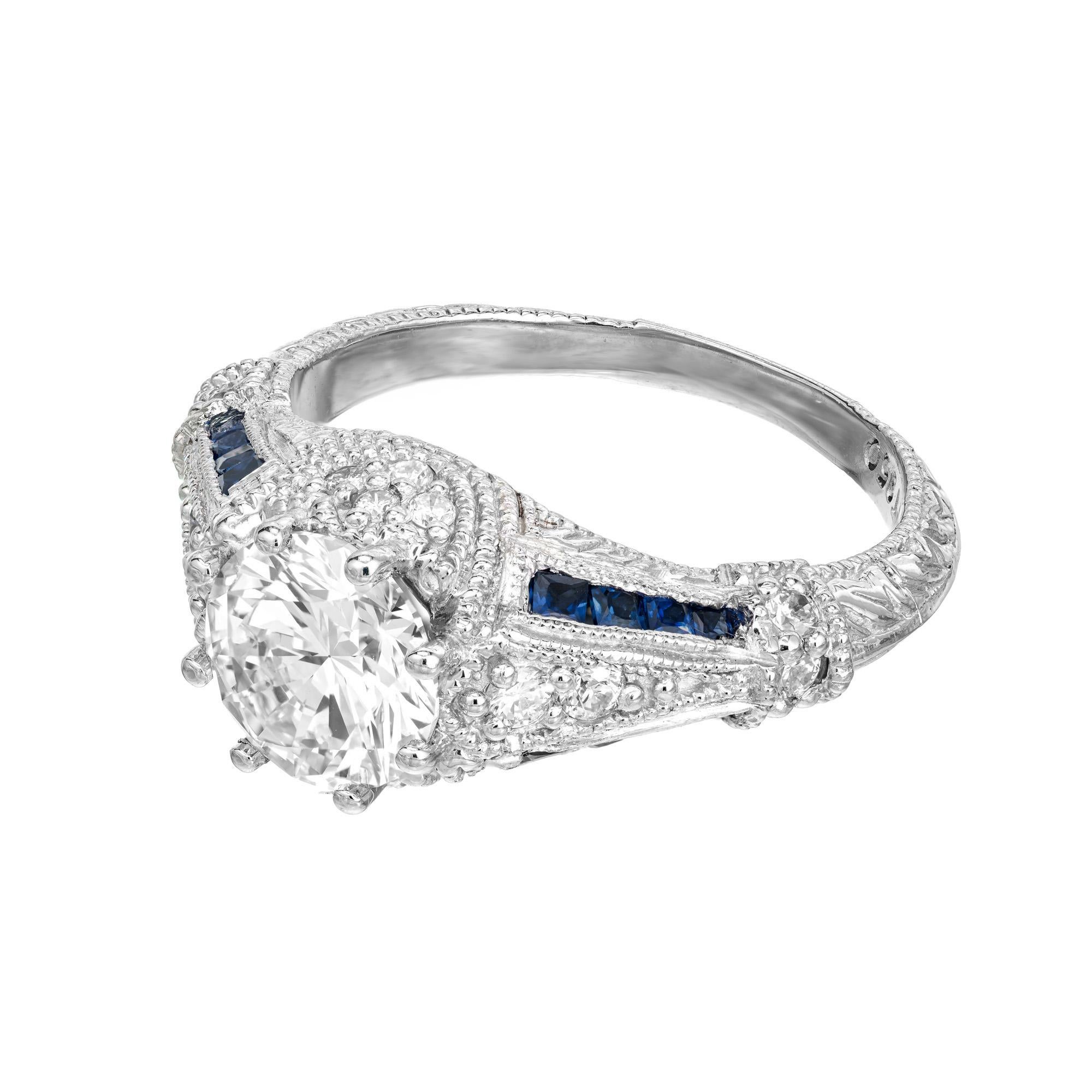 Diamond and sapphire engagement ring. GIA certified 1.51ct round brilliant cut center diamond, mounted in a platinum 8 prong setting. This ring is highly detailed, accented with 18 full cut round dimaonds and two rows of square cut sapphires along