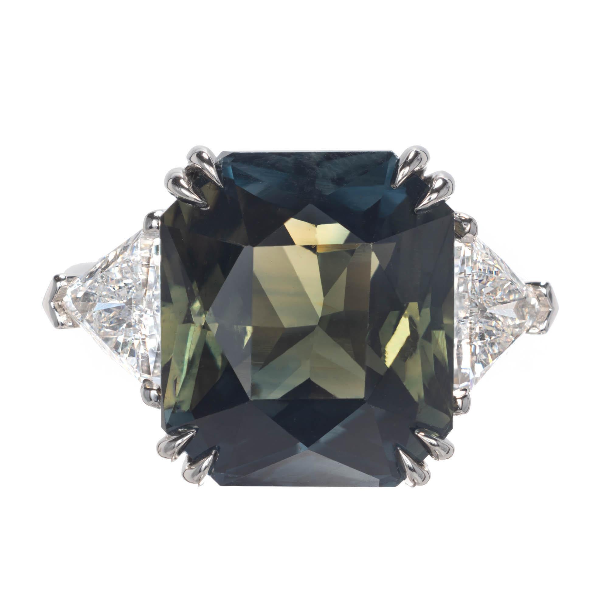 Ocatgonal cut sapphire and diamond three-stone ring. The center stone is a rich mix of both blue and green color, accented by two trilliant cut side diamonds in a three-stone platinum setting. GIA certified natural no heat. The ring was designed and