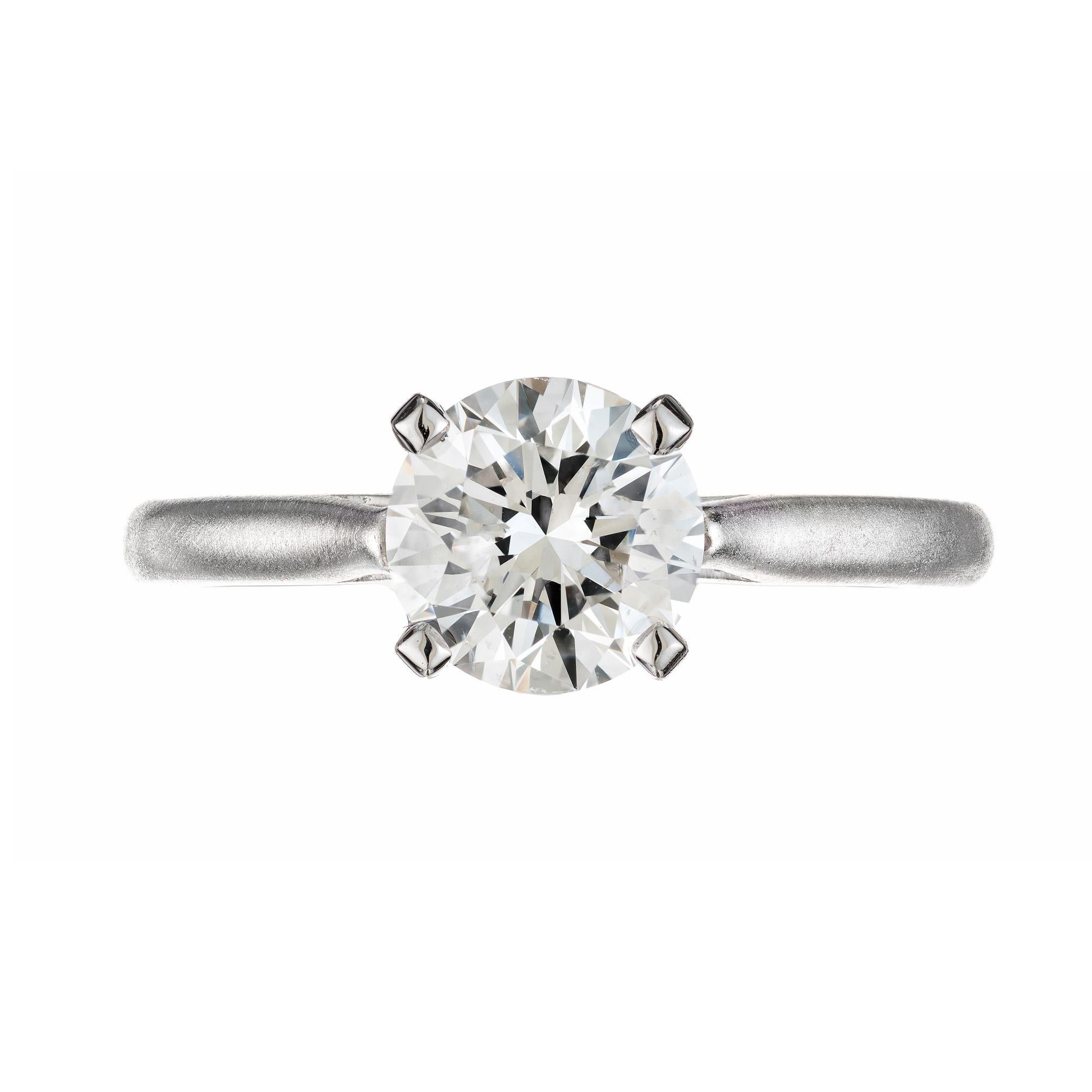 A modern twist on the classic solitaire. This 1.54 carat round diamond platinum solitaire is a newly crafted design in the Peter Suchy line that has evolved from various customer requests over the last 35 years. This platinum ring has a brushed