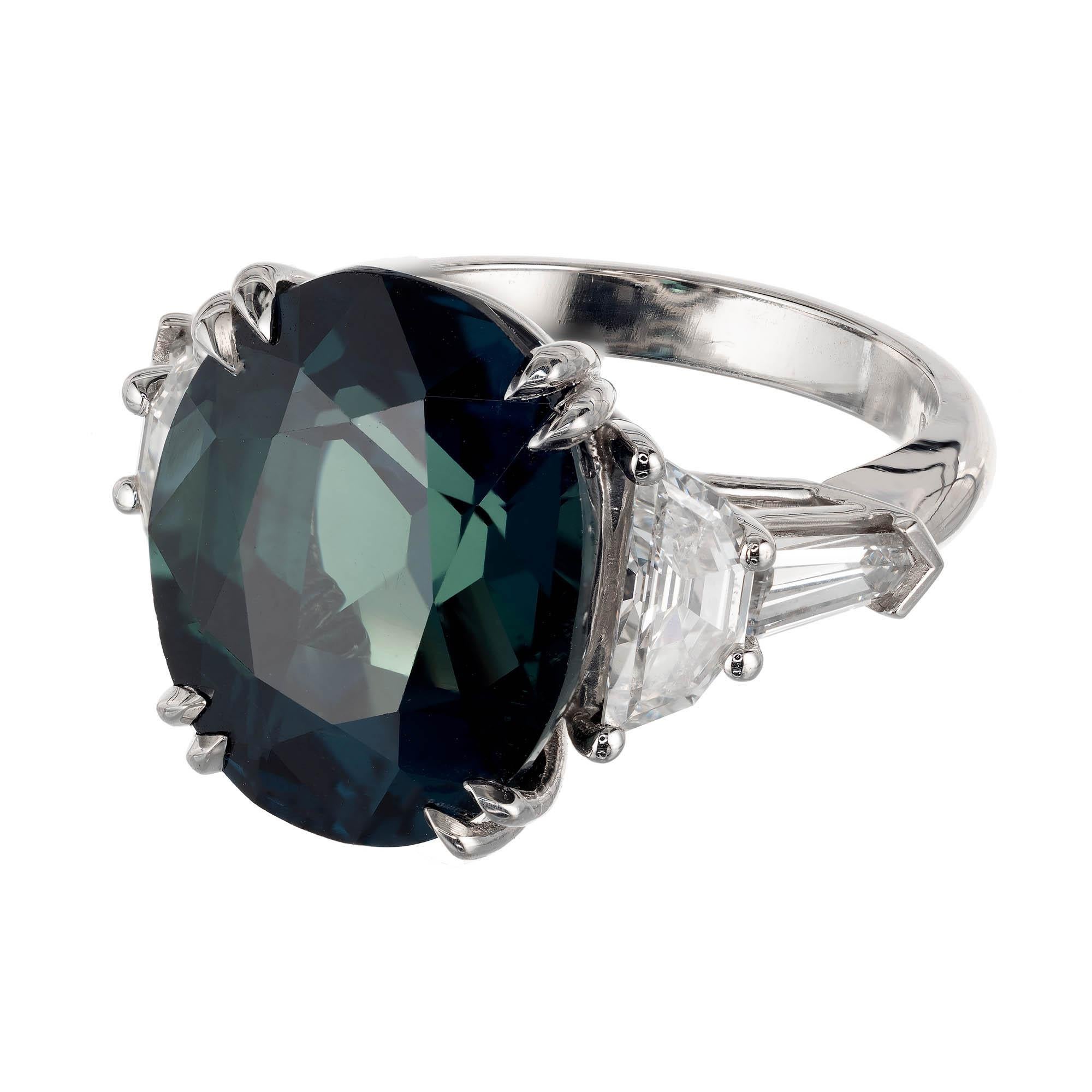 Teal green sapphire and diamond engagement ring. GIA certified natural no heat, untreated oval sapphire center stone, in a platinum setting with 2 half moon and 2 tapered baguette diamonds on each side of sapphire. Created in the Peter Suchy