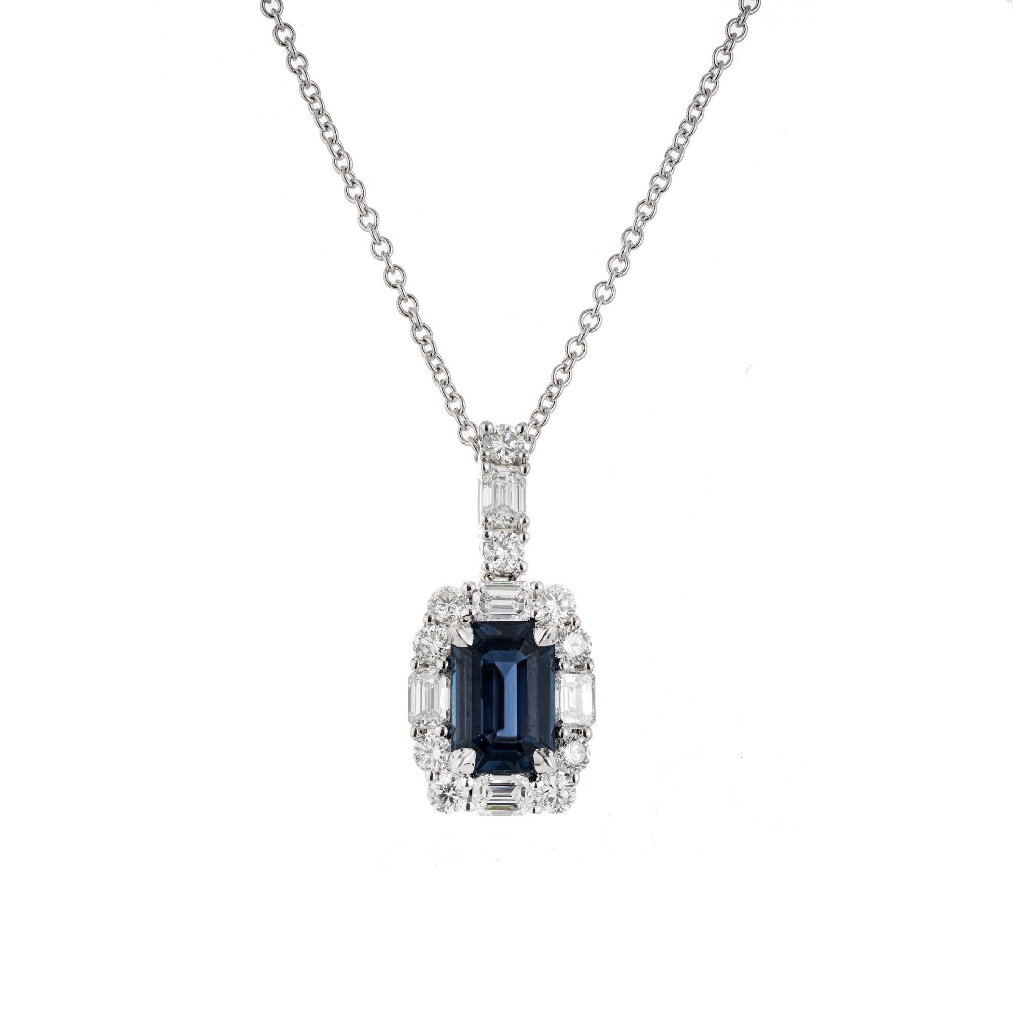 Sapphire and diamond pendant necklace. GIA certified emerald cut blue 1.63 carat sapphire. Set in a 14k white gold setting, accented with a halo of round and emerald cut diamonds along with diamonds on the bail. Art Deco inspired, this beautiful