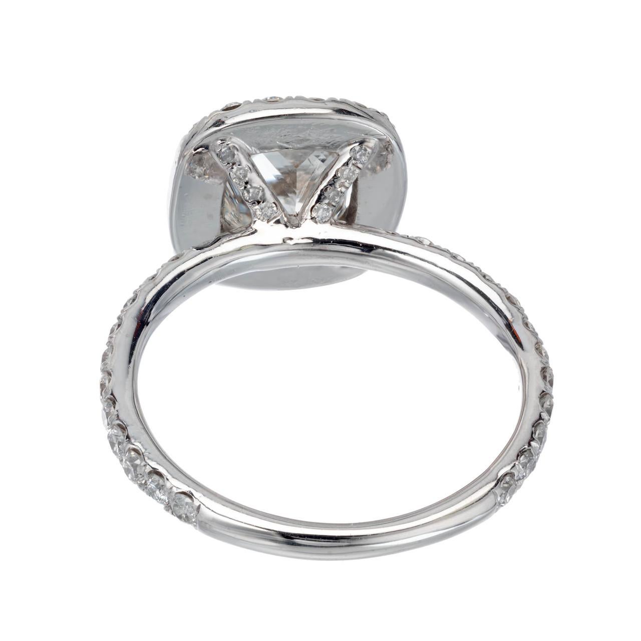 Radiant cut Diamond engagement ring. GIA certified center stone in a custom-made platinum diamond halo setting from the Peter Suchy Workshop. This design allows a wedding band to sit flush. 

1 radiant cut cornered rectangular H SI2, approx. 1.64cts