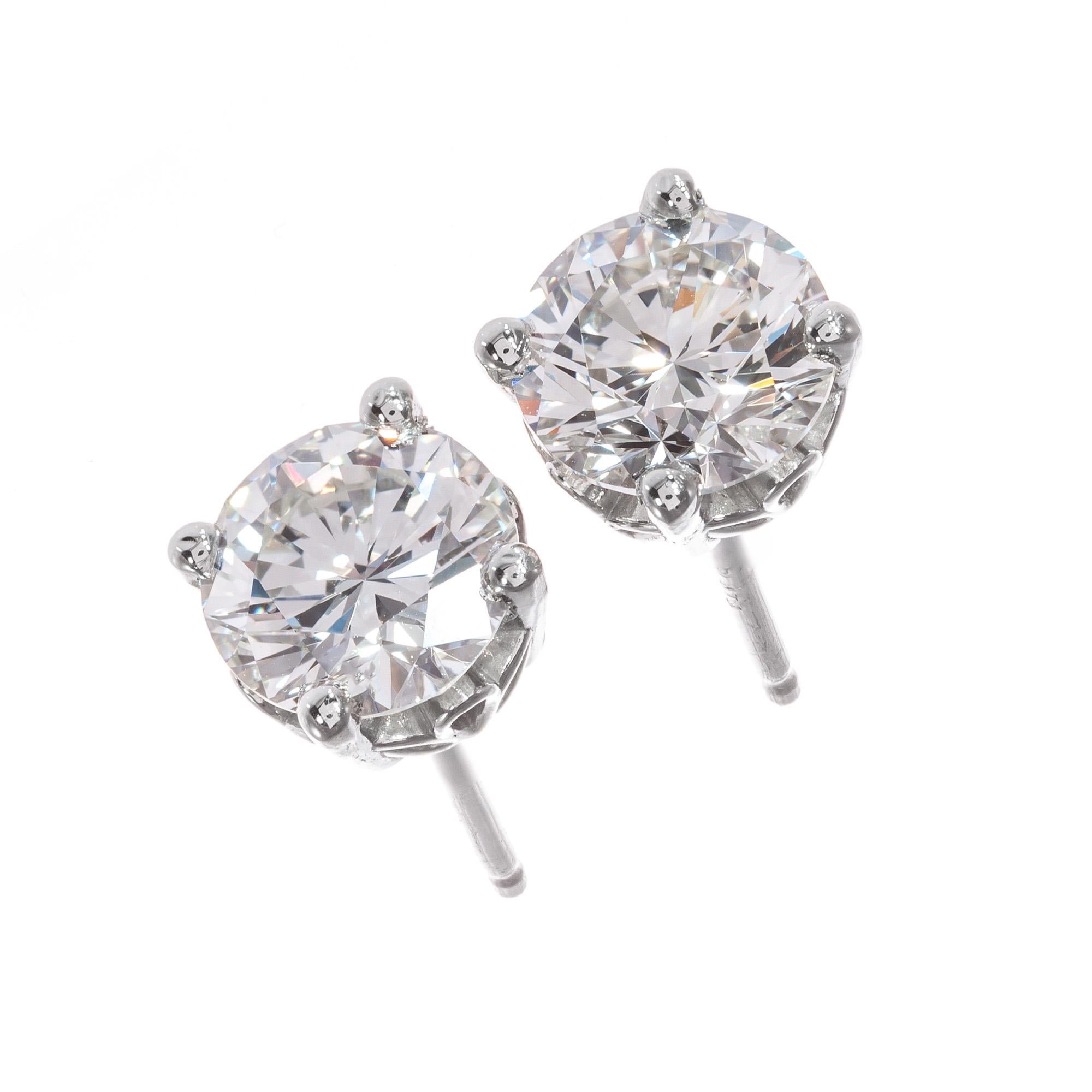 Well-cut bright sparkly diamond stud earrings. s from an estate. GIA certified round brilliant cut diamonds in a simple classic open work basket platinum setting, from the Peter Suchy Workshop. 

1 round brilliant cut J VS diamond, Approximate