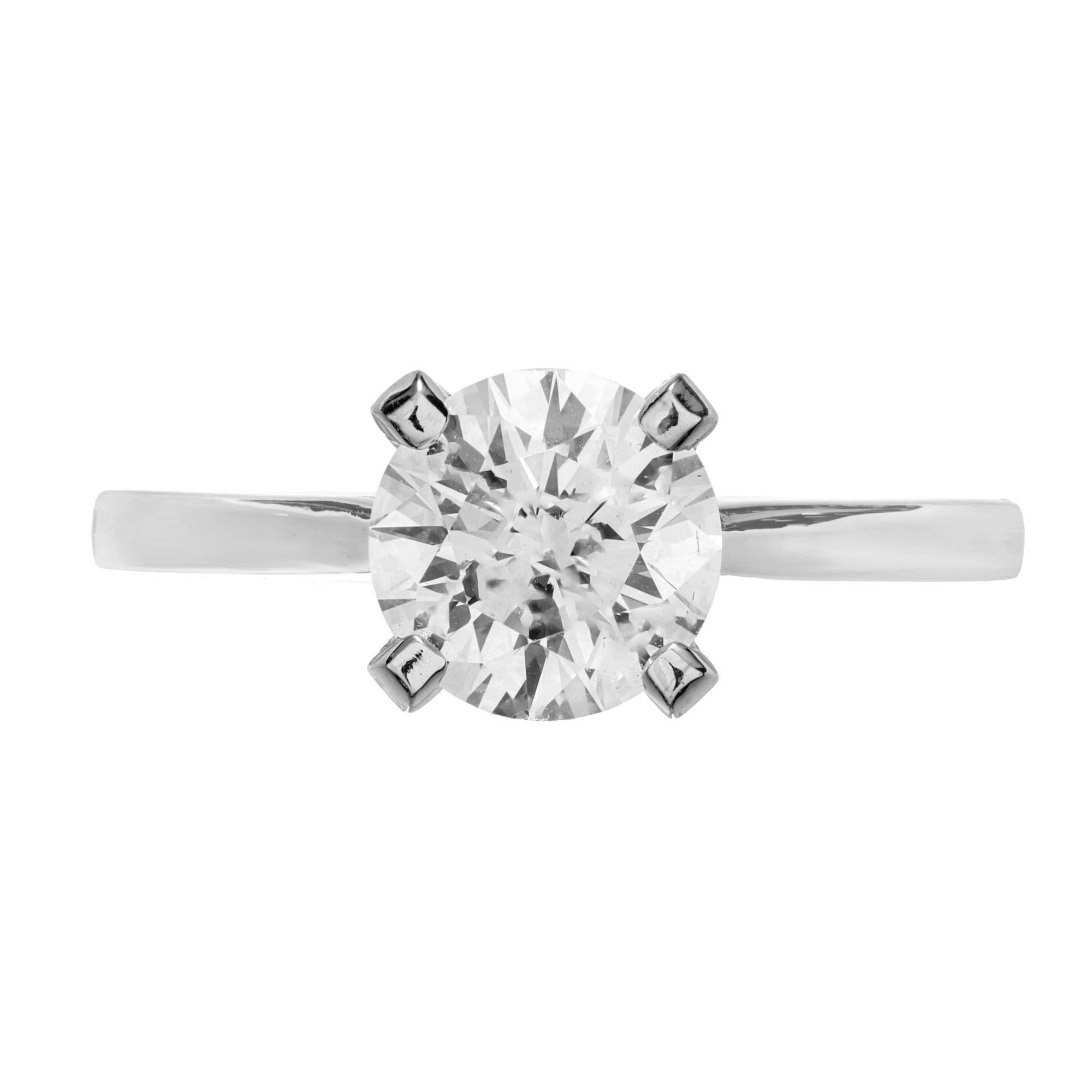 Simple classic diamond engagement ring with a few special features. First, the diamond is set low to the finger for comfort and safety. Second, the ring is engineered to to fit flus with a wedding band. GIA certified round brilliant cut center