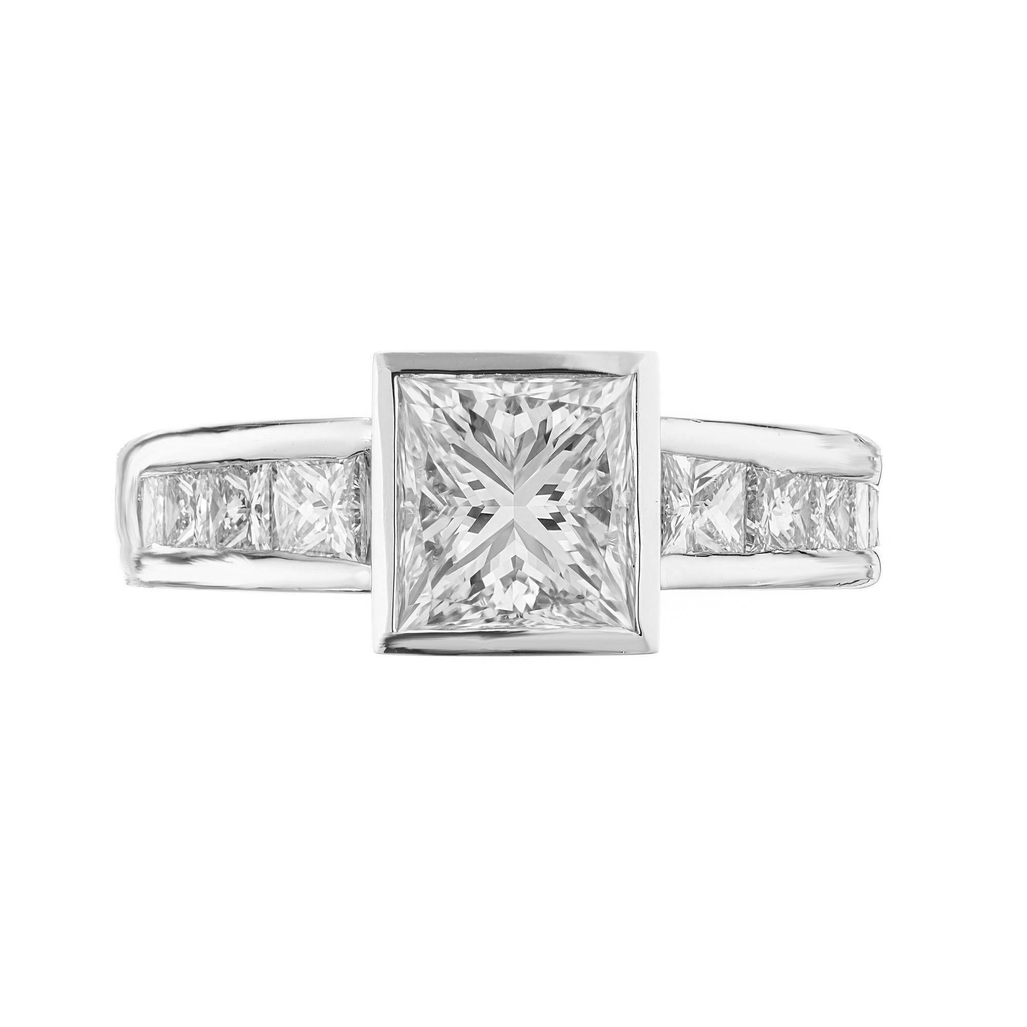 Diamond engagement ring. GIA certified princess cut, bezel set center stone.  Set in platinum with 10 princess cut graduated, channel set accent diamonds.  Created in the Peter Suchy Workshop. 

1 princess cut diamond, H VS2 approx. 1.70cts GIA