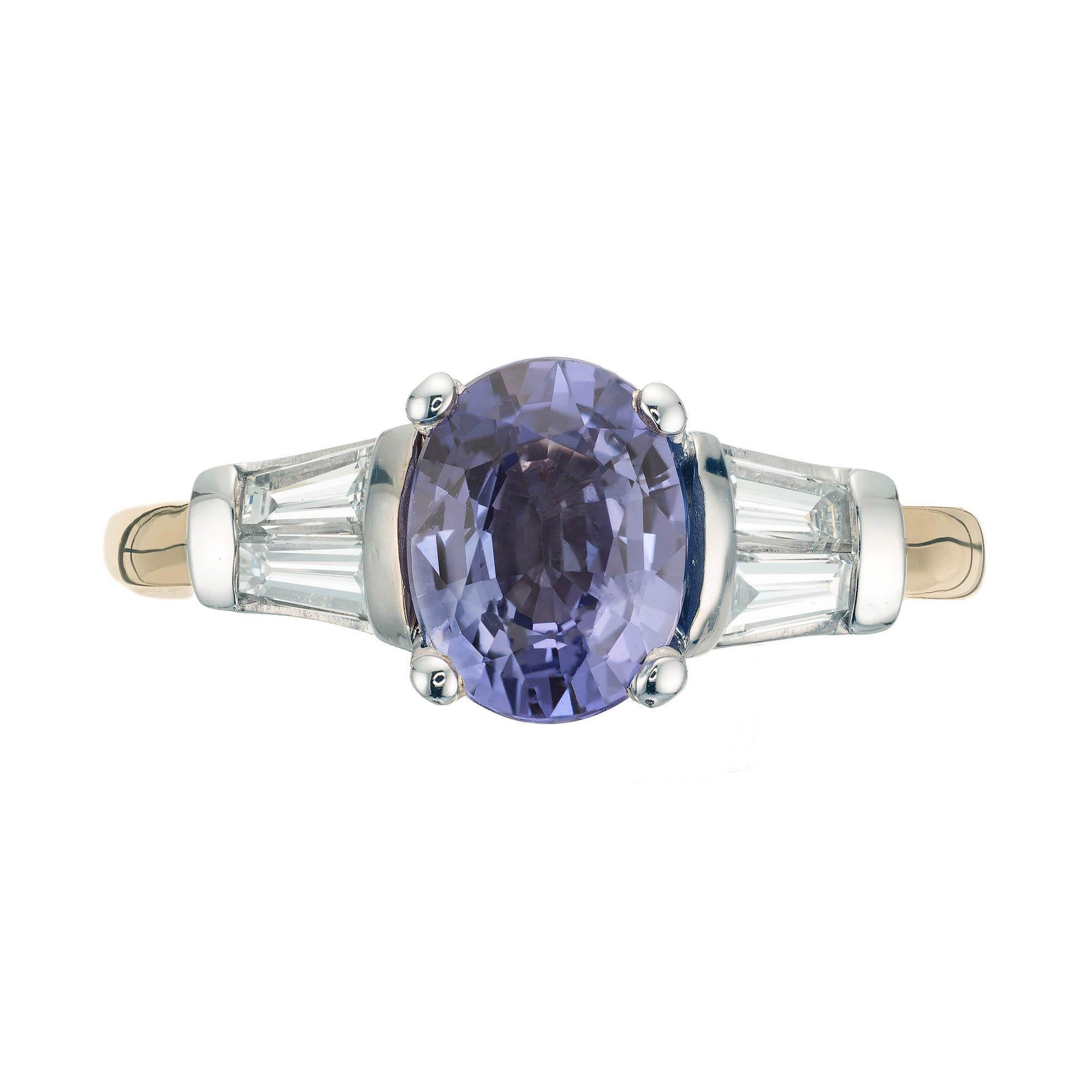 Peter Suchy  oval sapphire and diamond engagement ring. 18k yellow and white gold setting with two baguette diamonds. 

1 oval step cut violet/purple sapphire, Approximate 1.70ct GIA certificate # 2185764272 
4 tapered baguette H-I VS diamonds,