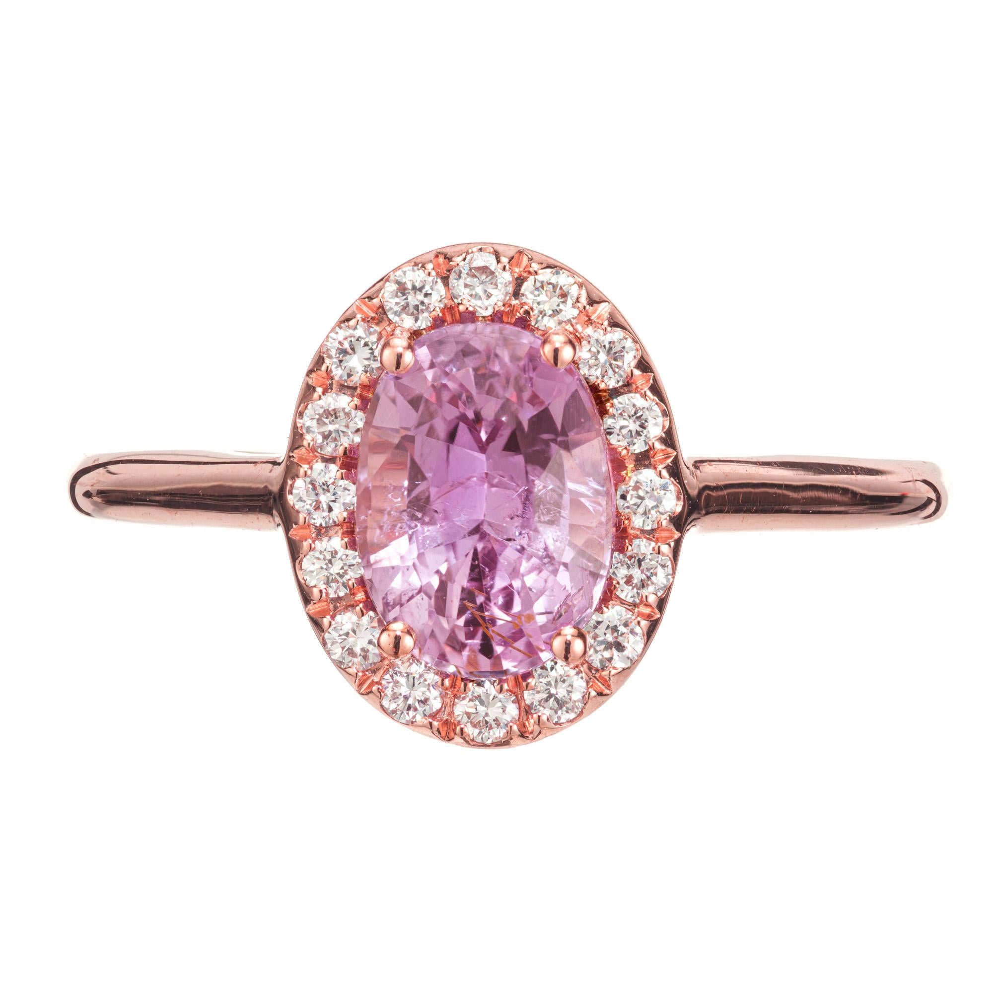 Bright pink sapphire and diamond engagement ring. GIA certified oval 1.70 carat center sapphire in a 14k rose gold setting with a halo of 16 round brilliant cut diamonds. Designed and crafted in the Peter Suchy Workshop.

1 oval pink purple