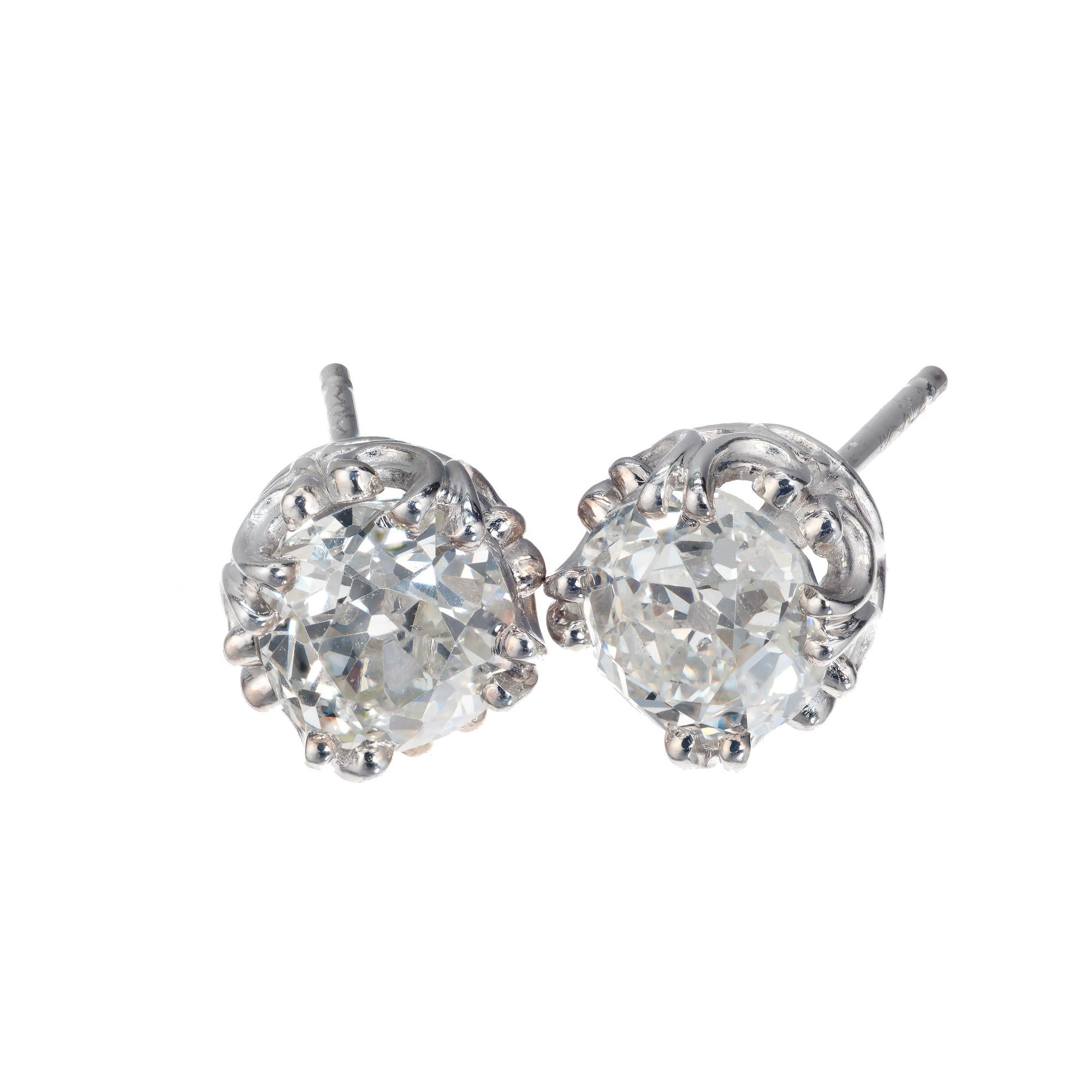 Peter Suchy old mine cut diamond stud earrings with two bright white sparkly estate diamonds in a filigree antique setting.

1 old mine cut K VS diamond, Approximate .82cts GIA Certificate # 1192681402
1 old mine cut I SI diamond, Approximate .98cts