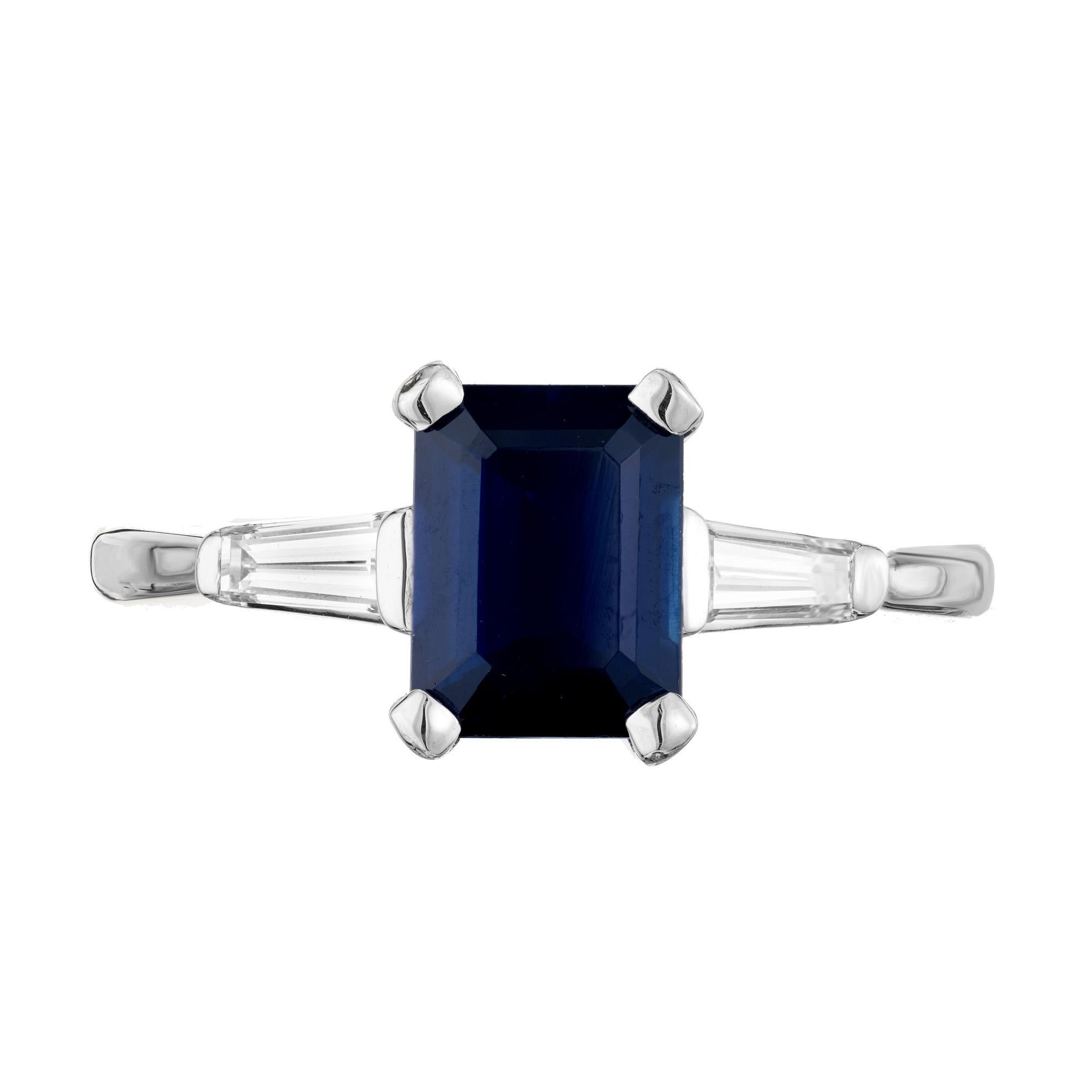 Sapphire and diamond engagement ring. GIA certified octagonal 1.80ct blue sapphire center stone, mounted in a platinum three-stone setting. Accented with two tapered baguette side diamonds. The sapphire is GIA certified as simple heat only. Simple