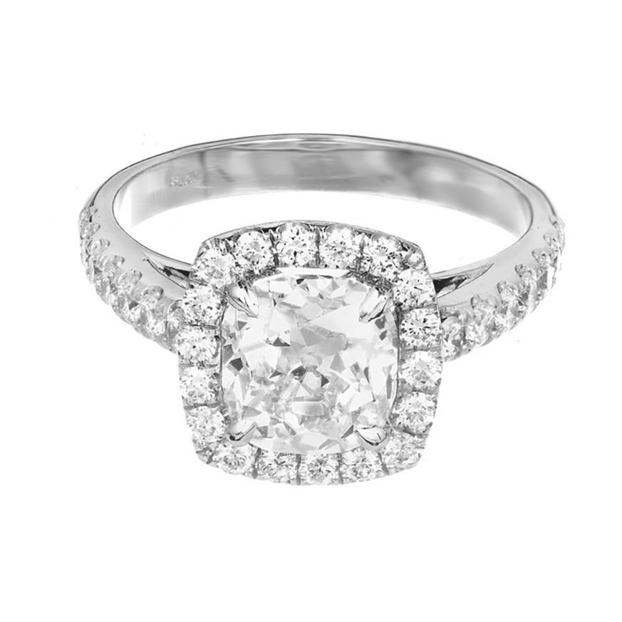 Diamond halo platinum engagement ring. The center piece of this setting is an Old Mine brilliant cut 1.81ct diamond accented with a halo of round diamonds. The sides of the shank are adorned with round cut diamonds. The sides taper to allow a