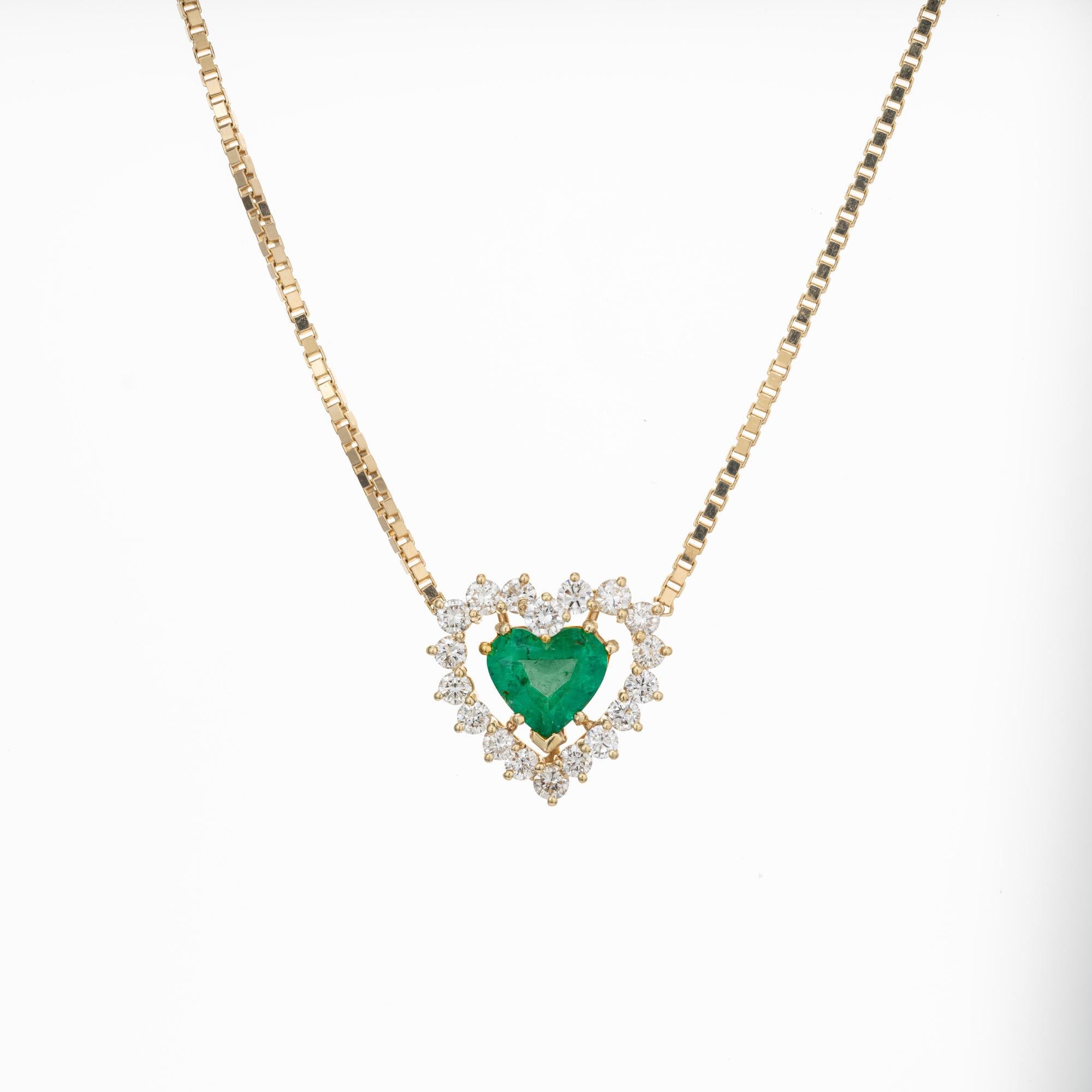 Emerald heart and diamond necklace pendant. GIA Certified 1.81 carat natural heart shaped emerald set in 18k yellow gold setting with a halo of 18 round brilliant cut diamonds totaling 1.10cts. 18k yellow gold adjustable box chain that can be worn