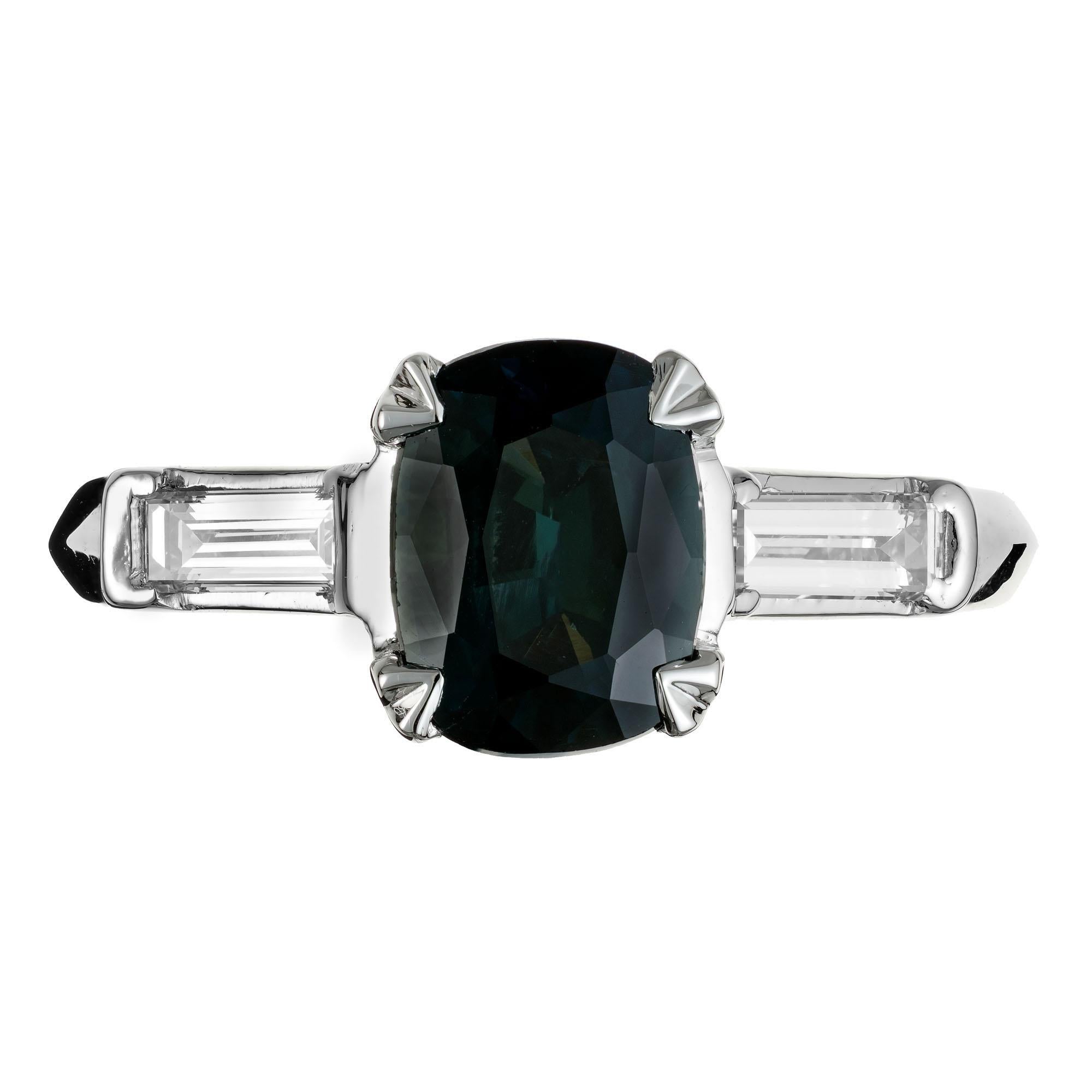 Natural green sapphire and diamond engagement ring. GIA Certified natural untreated oval cushion cut sapphire in a platinum three-stone setting with two baguette cut side diamonds.  from an estate circa 1920. The setting is designed and crafted in