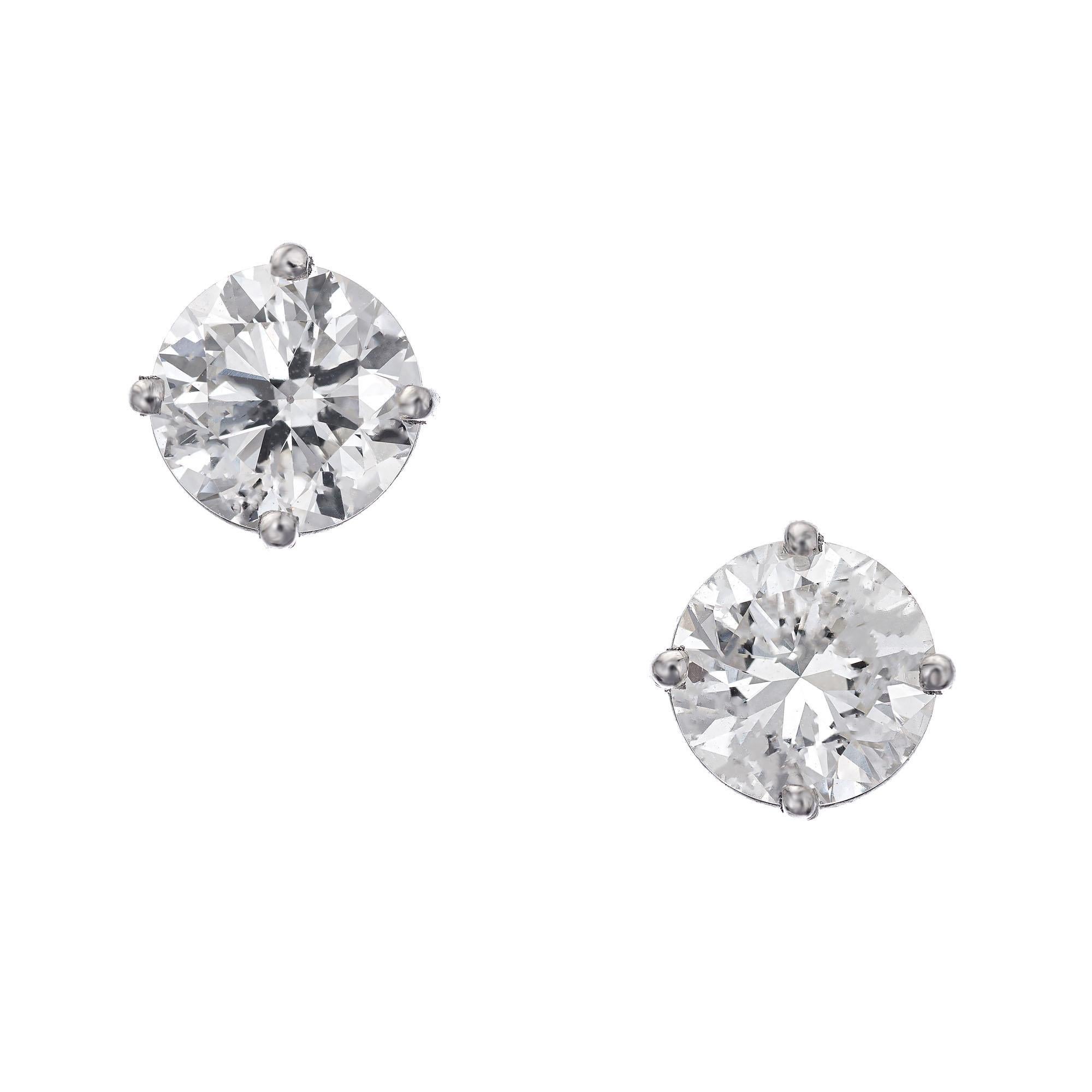 Peter Suchy diamond stud earrings. 2 GIA certified round brilliant cut diamonds in 4 prong platinum baskets created in the Peter Suchy Workshop. 

1 round brilliant cut K VS2 diamond, Approximate .91 Carats Gia Certificate # 2175424288
1 round