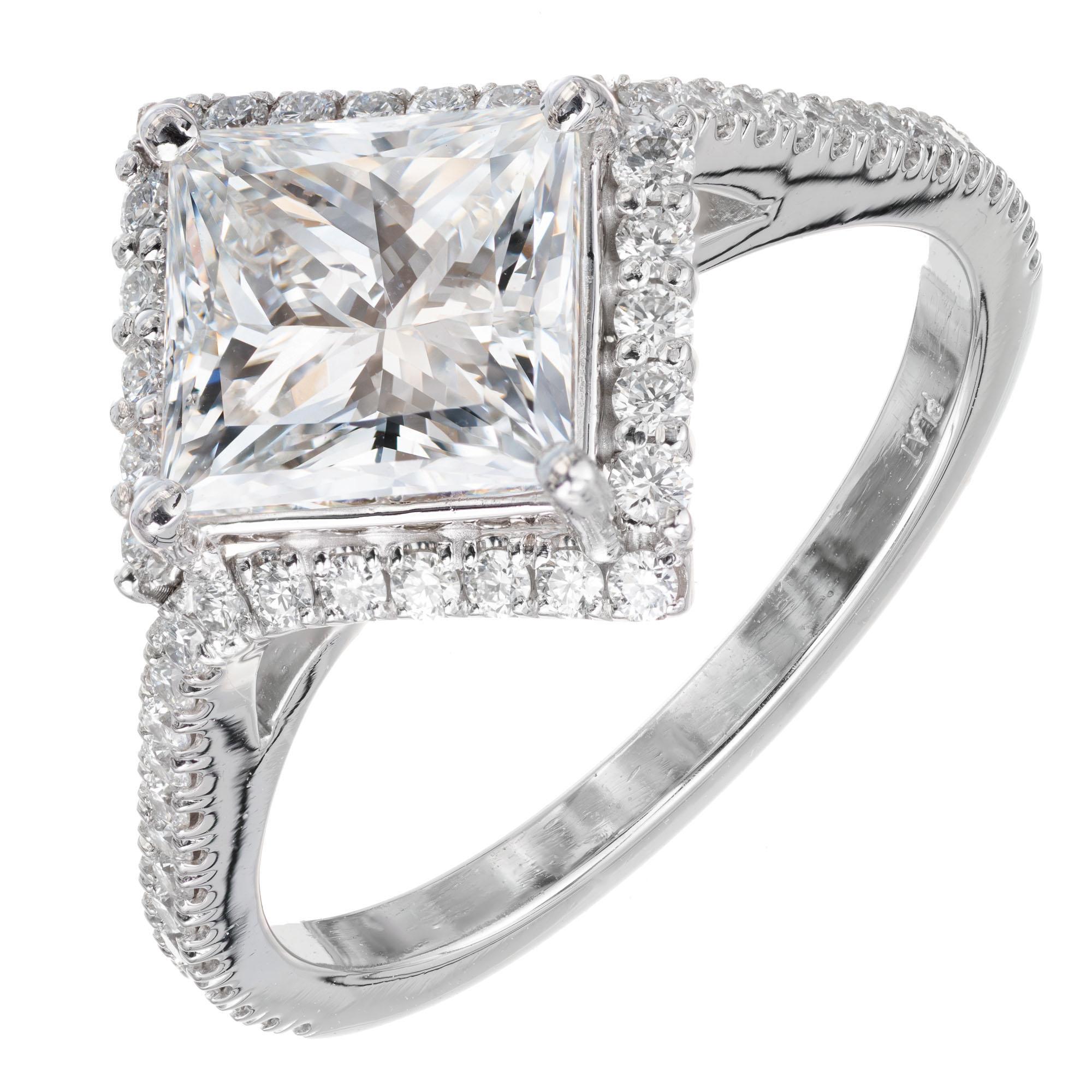GIA Certified 1.85ct princess cut diamond center stone, with a halo of 50 round brilliant accent diamonds, in a platinum setting. Made in the Peter Suchy Workshop  

1 square modified brilliant diamond F VS2, approx.  1.95cts GIA Certificate
