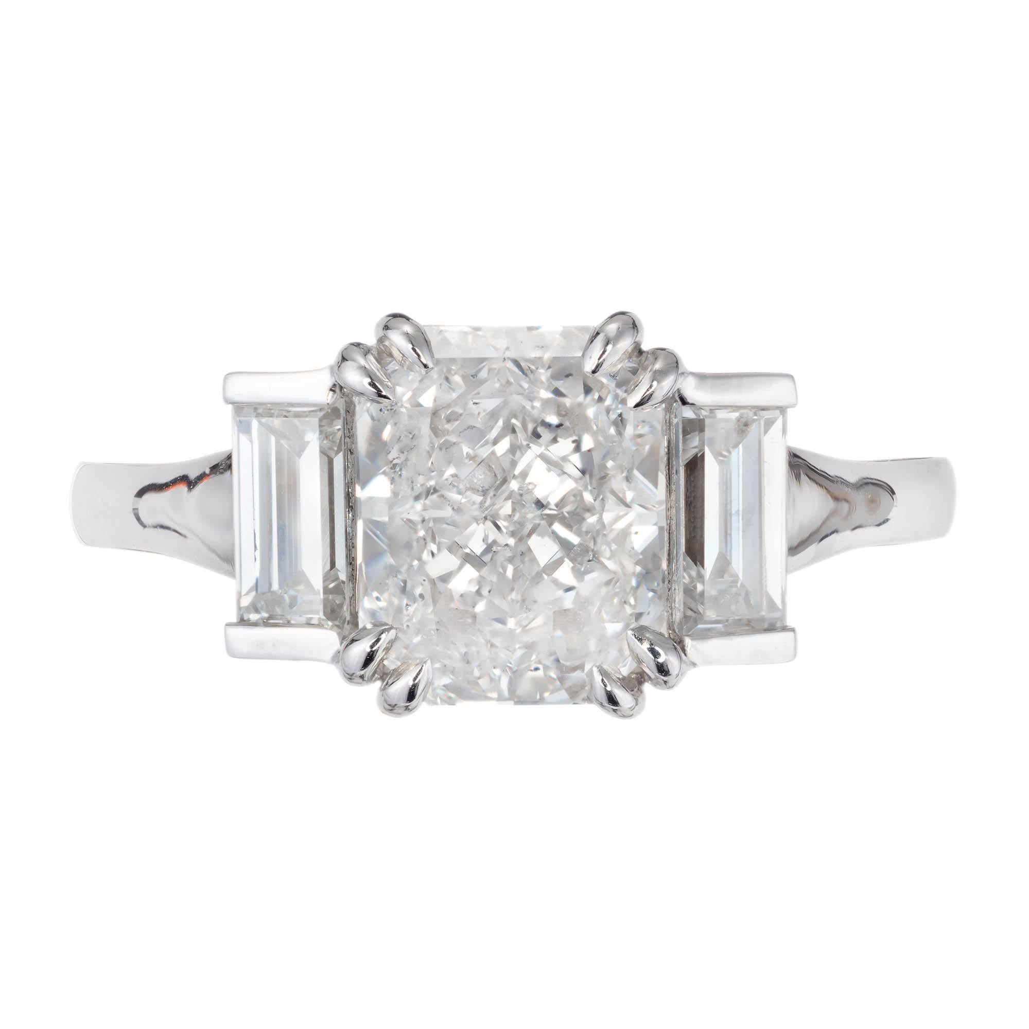 Peter Suchy Art Deco Inspired diamond engagement ring. 2.01 carat radiant cut center diamond certified by the GIA. Accented by two emerald cut side diamonds, in a platinum setting. 

1 cut cornered rectangular brilliant F I diamond, Approximate 2.01