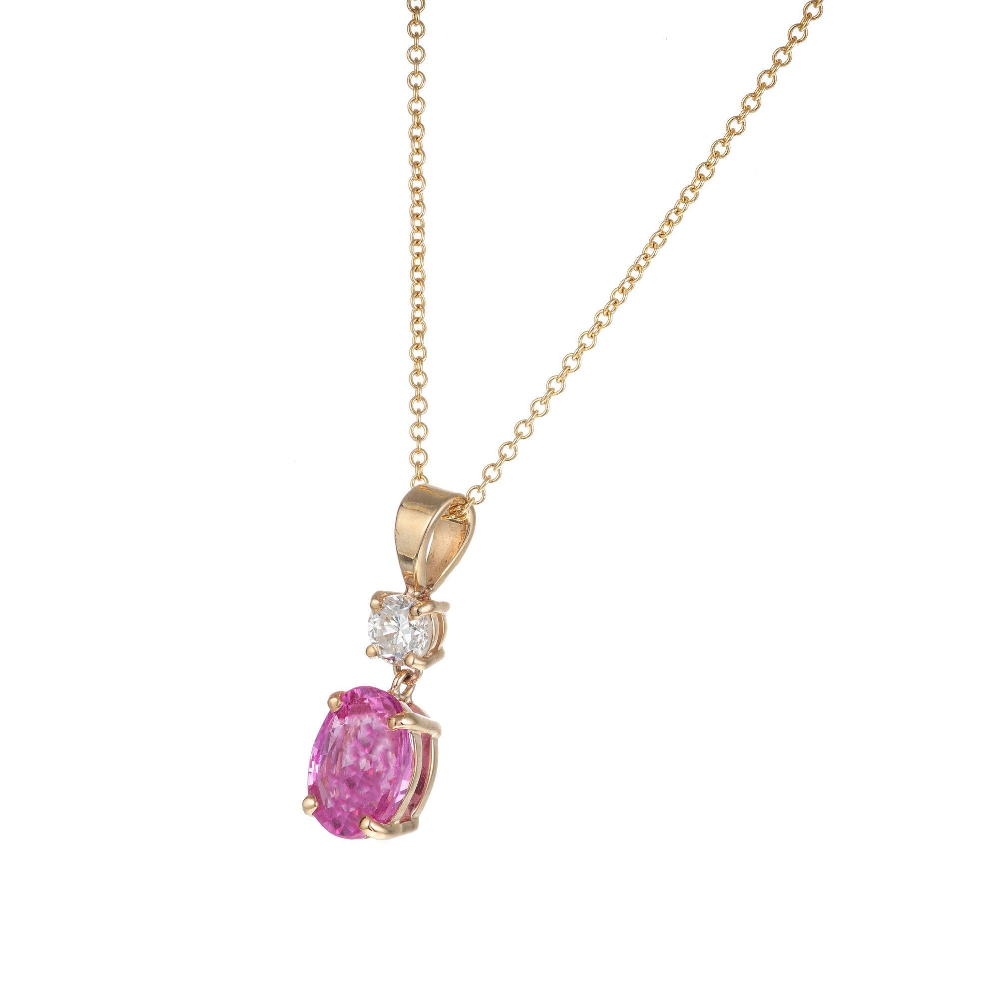 GIA certified natural pink sapphire and diamond pendant necklace. Simple heat only Oval pink sapphire with one round brilliant cut accent diamond set in 14k yellow gold, 18 inch chain. Simple heat only. Designed and created in the Peter Suchy