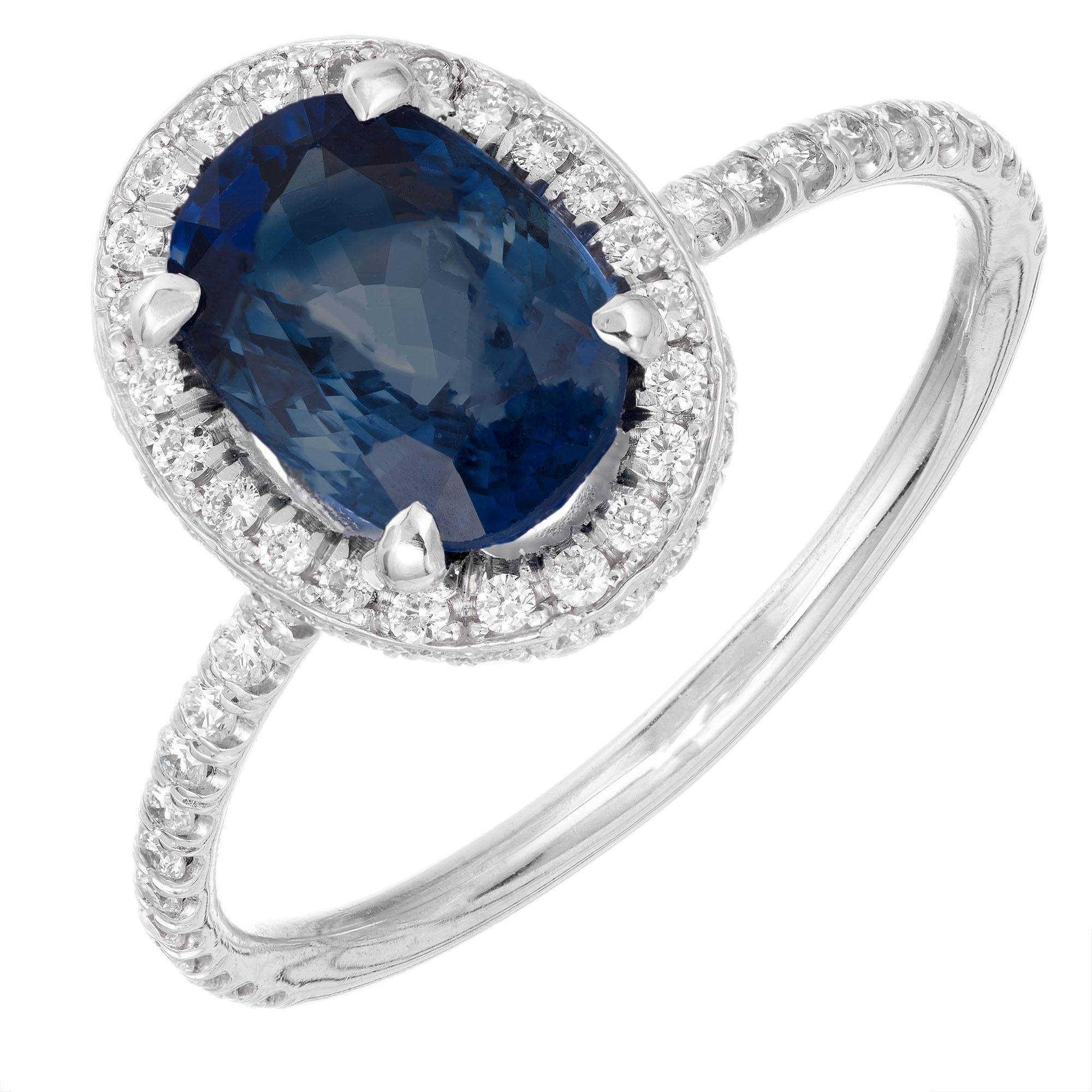 Blue GIA certified 2.02 carat oval sapphire and diamond engagement ring. Oval center stone with a halo of round diamonds. Designed and created in the Peter Suchy Workshop.

1 oval blue sapphire VS2, approx. 2.02cts GIA Certificate # 6204733832
93