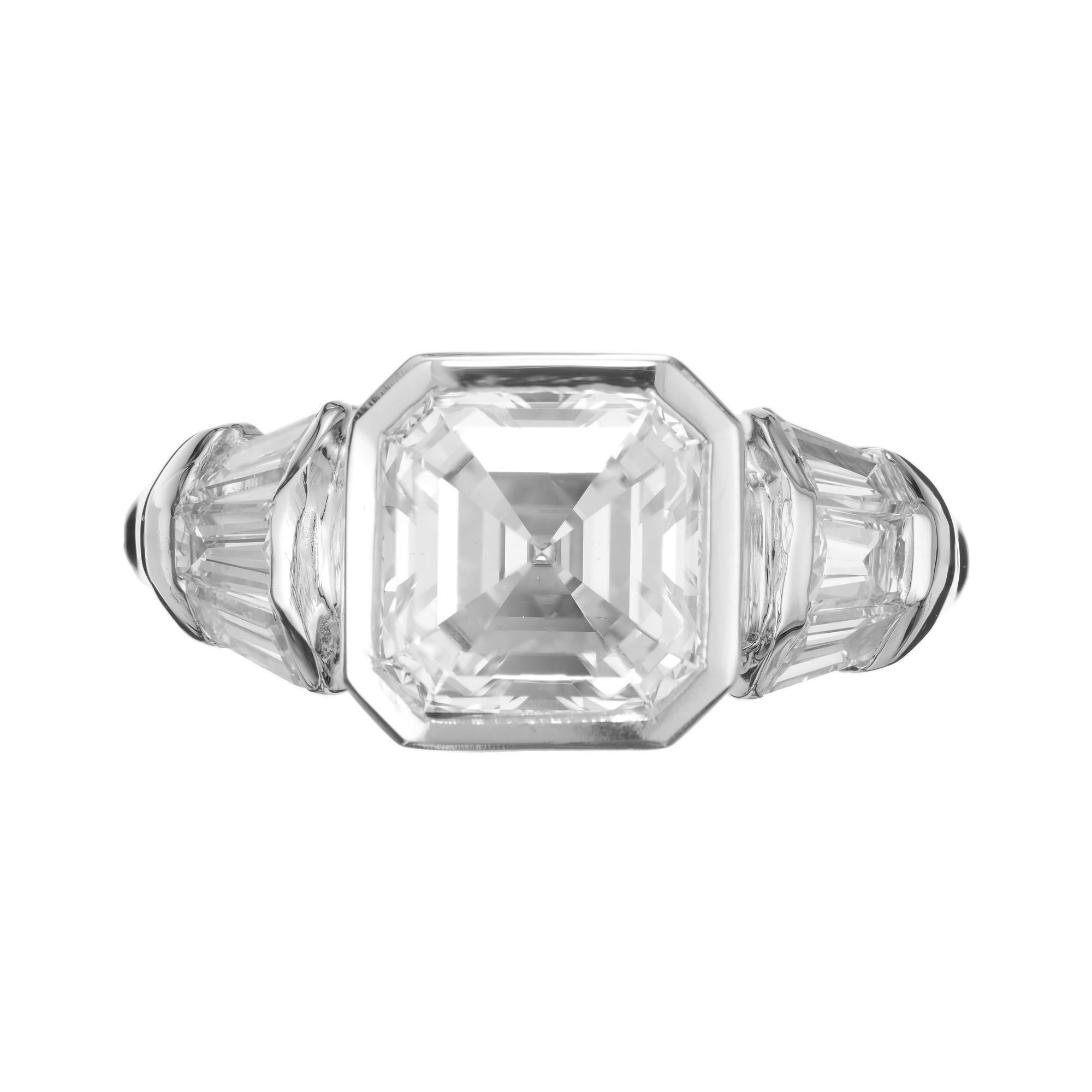 Square cut diamond engagement ring. This GIA certified 2.04 carat square emerald cut center diamond is graded F color, near colorless and bezel set in to a platinum setting, accented with 3 tapered baguette diamonds one each side of the main stone.