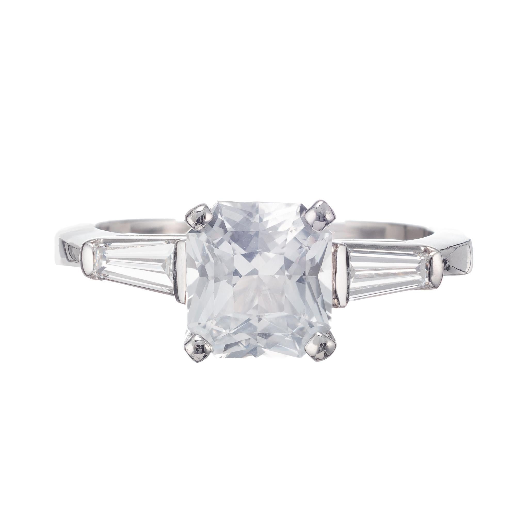 Natural no heat octagonal 2.07 carat sapphire and diamond three-stone engagement ring. Gia certified center stone accented with 2 tapered baguette diamond in a platinum setting made in the Peter Suchy Workshop. 

1 octagonal square white near