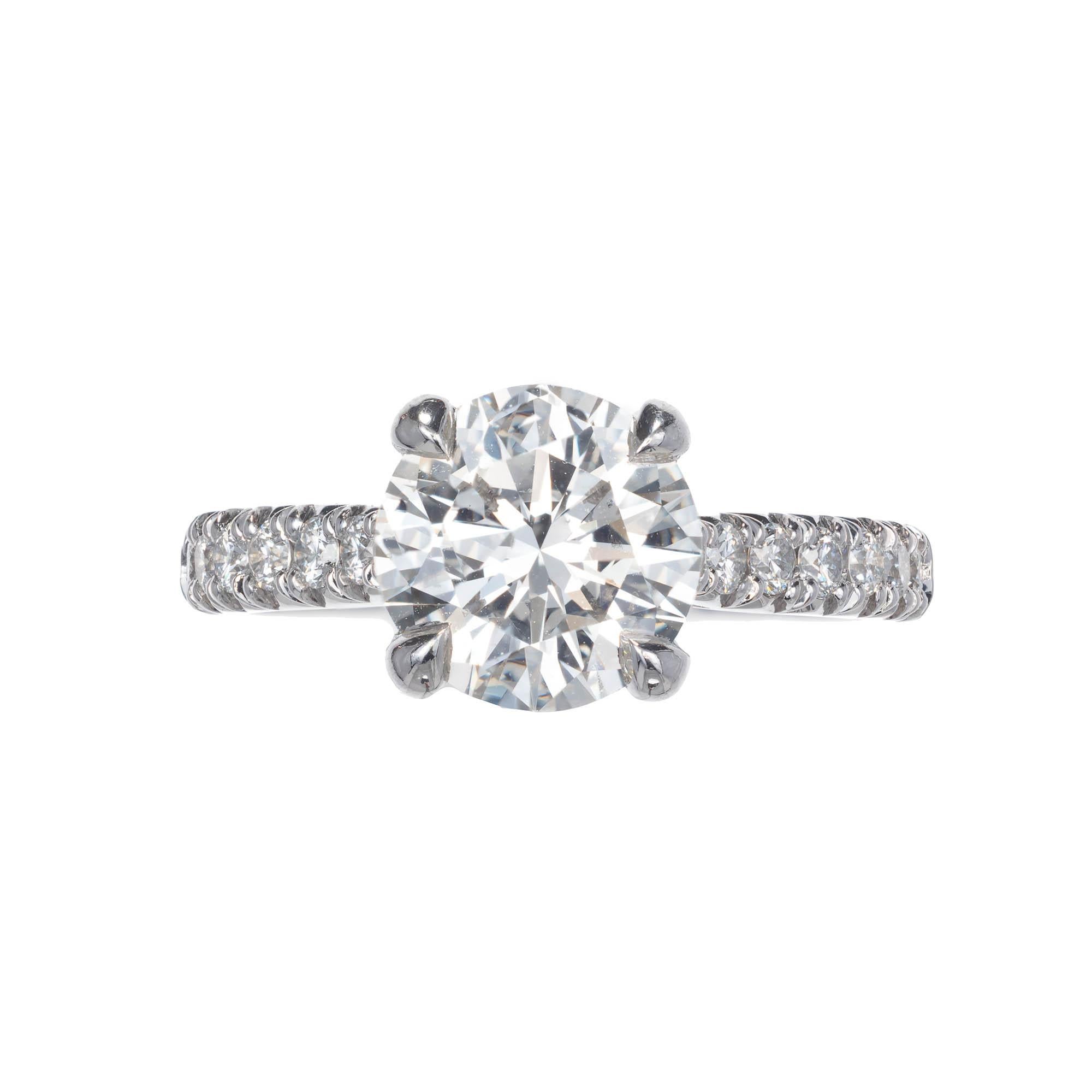  Classic 4 prong diamond solitaire that allows a band to fit flush with groove set Ideal cut diamonds coming gently up the sides.  Set with a sparkly GIA certified 2.08ct, I color VS2 diamond. From the Peter Suchy Workshop 

1 round diamonds