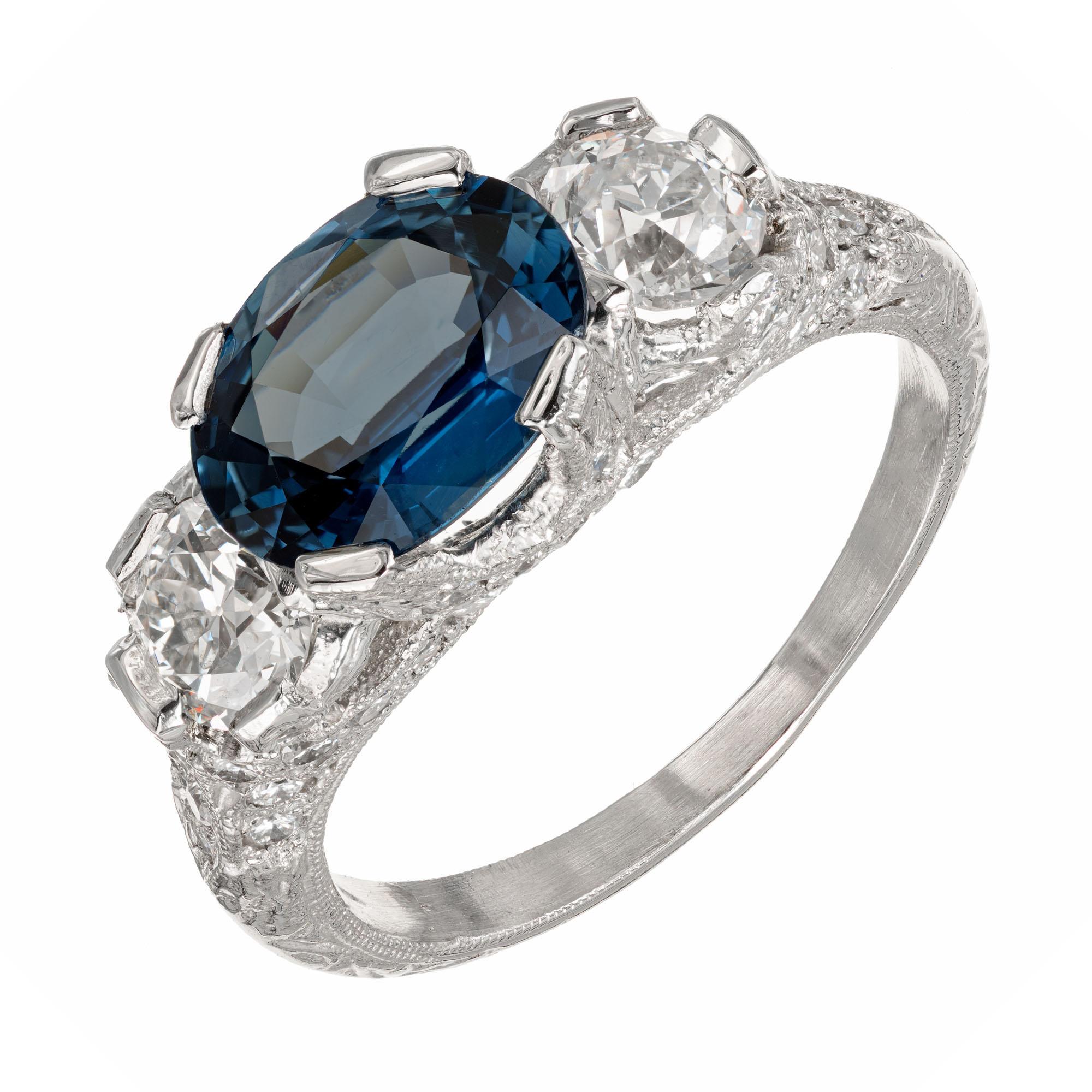 Peter Suchy Antique Inspired sapphire and diamond engagement ring.  Complete with crossed prongs, hand engraving and pave diamonds.  The main stones are from an estate circa 1920 with European cut diamonds and a bright blue sapphire 2.11ct GIA