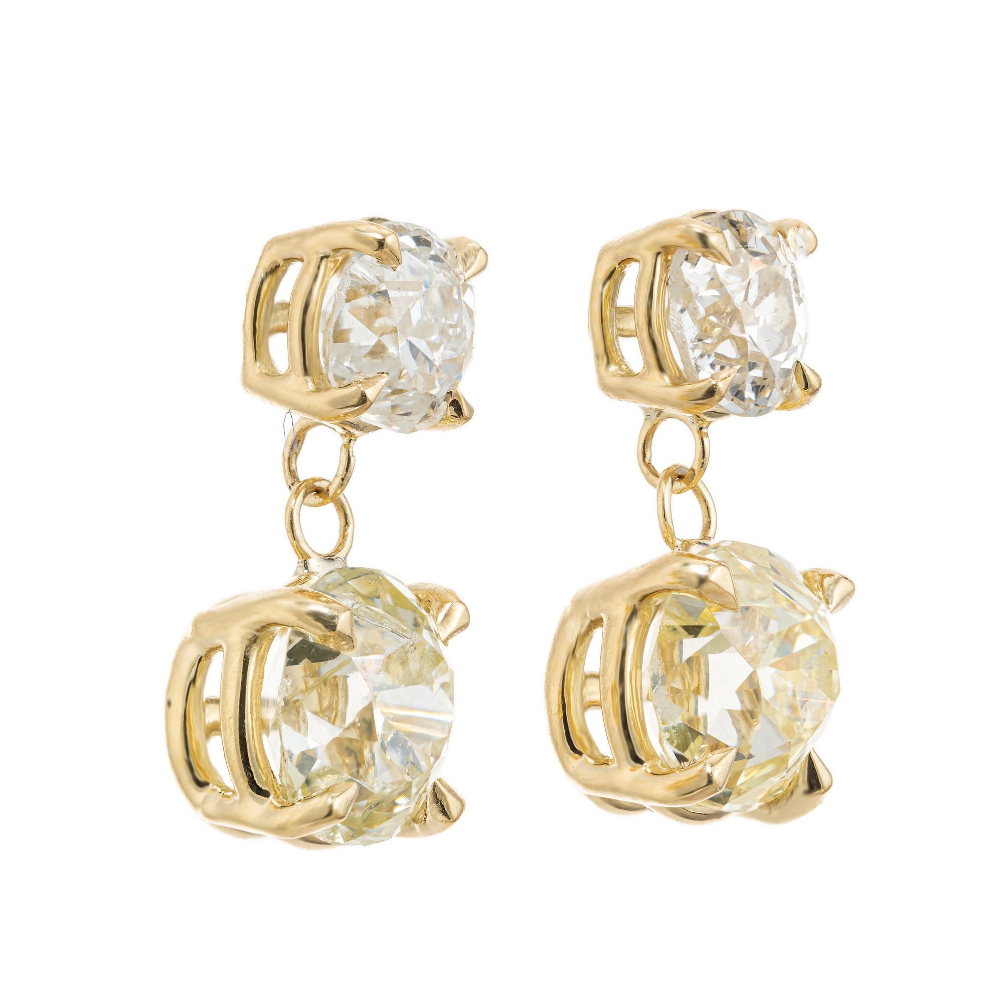 Diamond dangle earrings. 4 old mine brilliant cut diamonds set in four prong basket settings. 2 old mine top diamonds with 2 separately GIA certified light yellow well matched old mine brilliant cut diamonds, one at 1.16cts and the other at .98cts.
