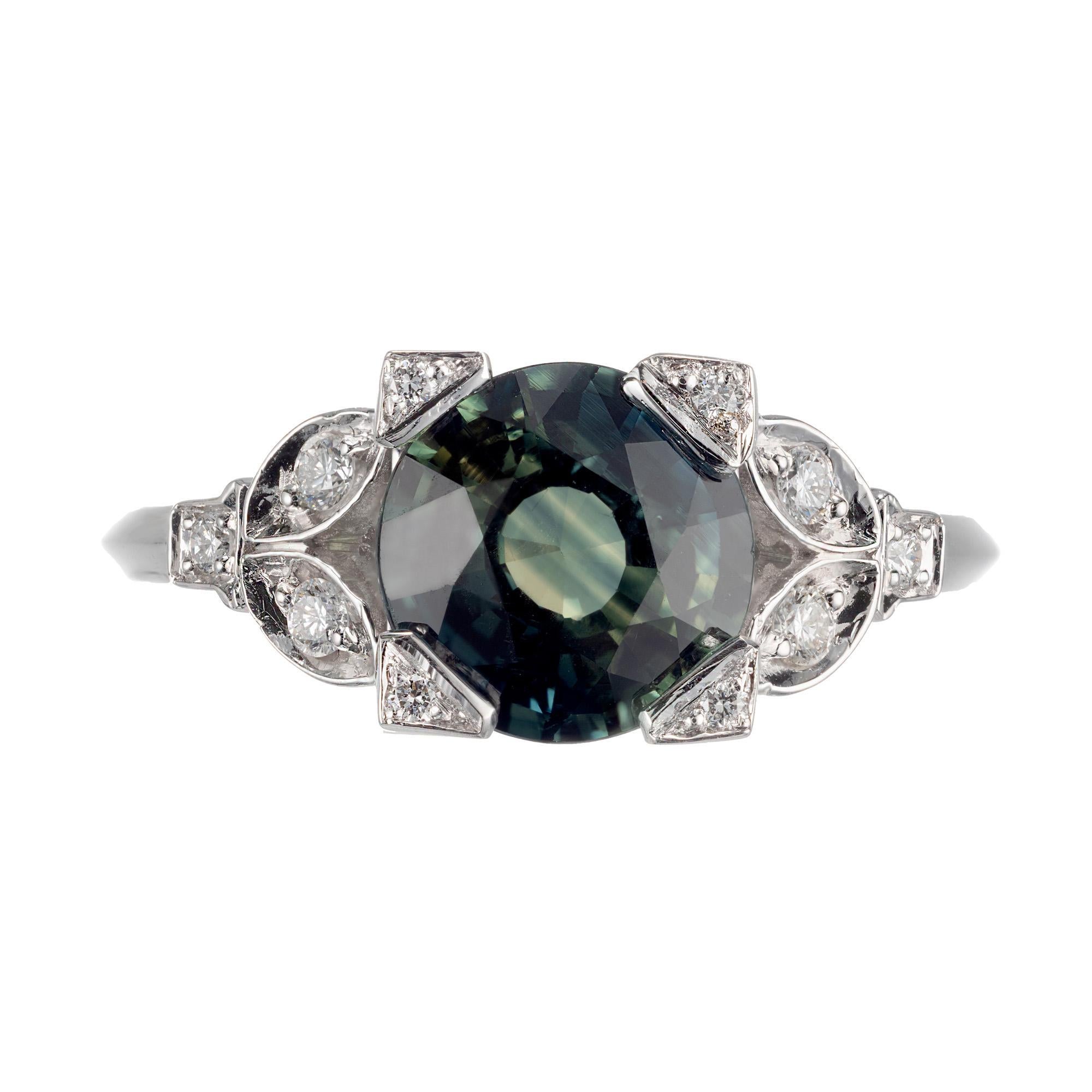 Round yellow/green sapphire and diamond engagement ring. GIA Certified natural no heat enhancement blue and greenish yellow sapphire, in a platinum setting with 16 round brilliant cut accent diamonds.  The setting was designed and made in the Peter