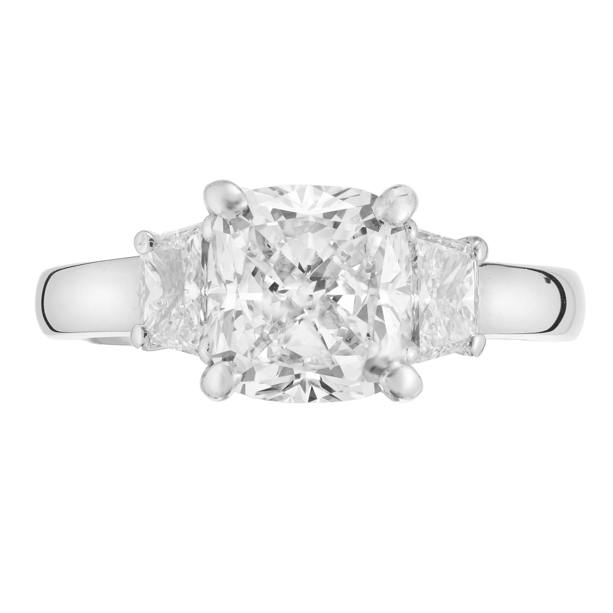 Classic and stunning three stone dimaond engagement ring. The center stone is a spectacular 2.28ct cushion brilliant cut diamond that is GIA certifed as near colorless. Mounted in at platinum setting that is crafted in the Peter Suchy Workshop, the