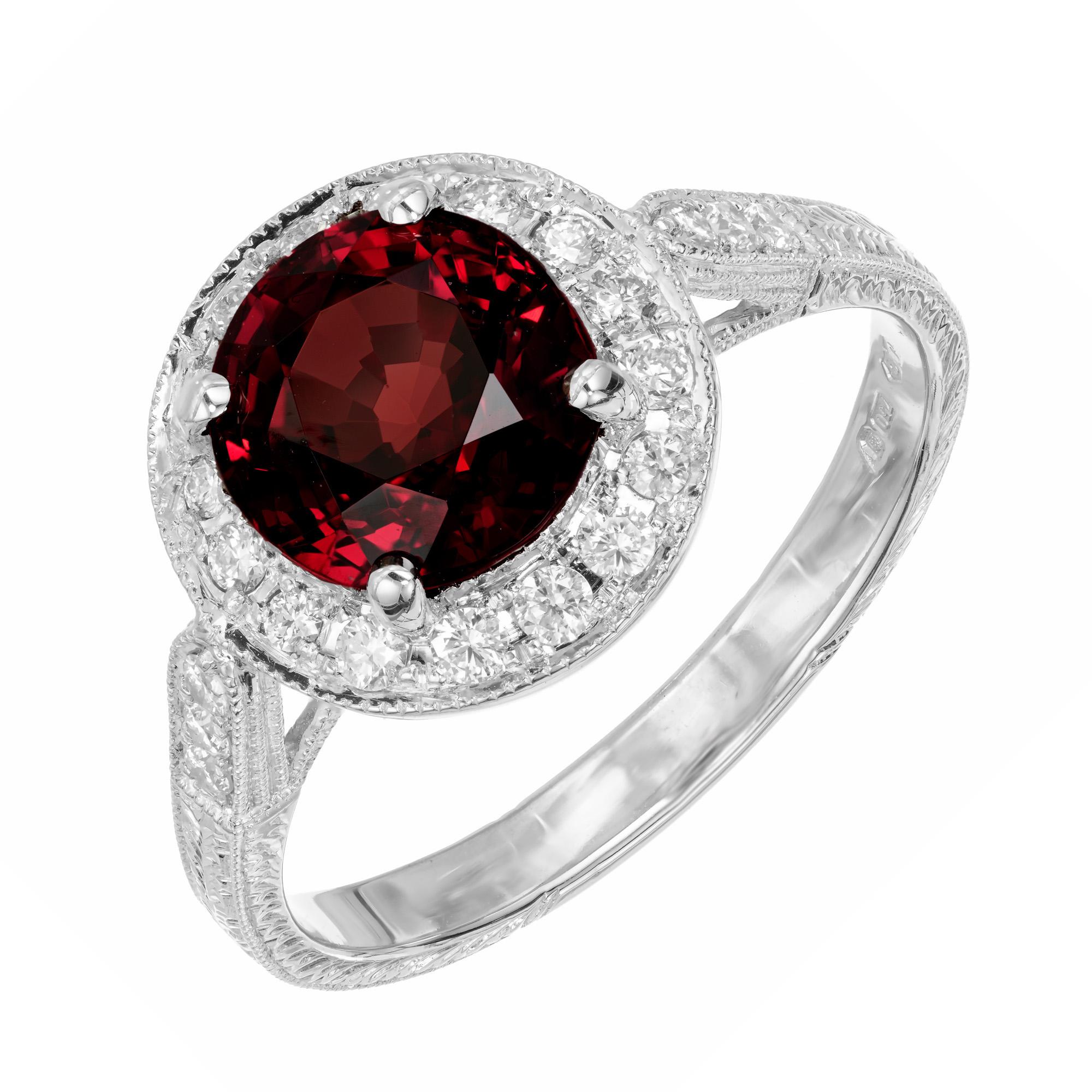 Spinel and diamond engagement ring. GIA certified untreated natural 2.42ct. center spinel with a halo of round brilliant cut diamonds in a 18k white gold setting with diamonds along the shank. Designed and created in the Peter Suchy Workshop.

1