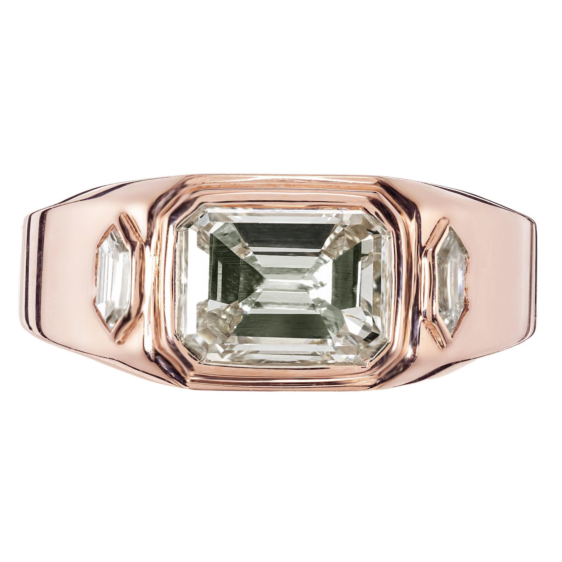 Diamond three-stone ring. Mounted in 18k rose gold, this 1920's GIA bezel set 2.45ct emerald cut diamond is graded N, very light yellow, accented with a pair of 1920's shield cut diamonds. The ring is designed in the Peter Suchy Workshop with