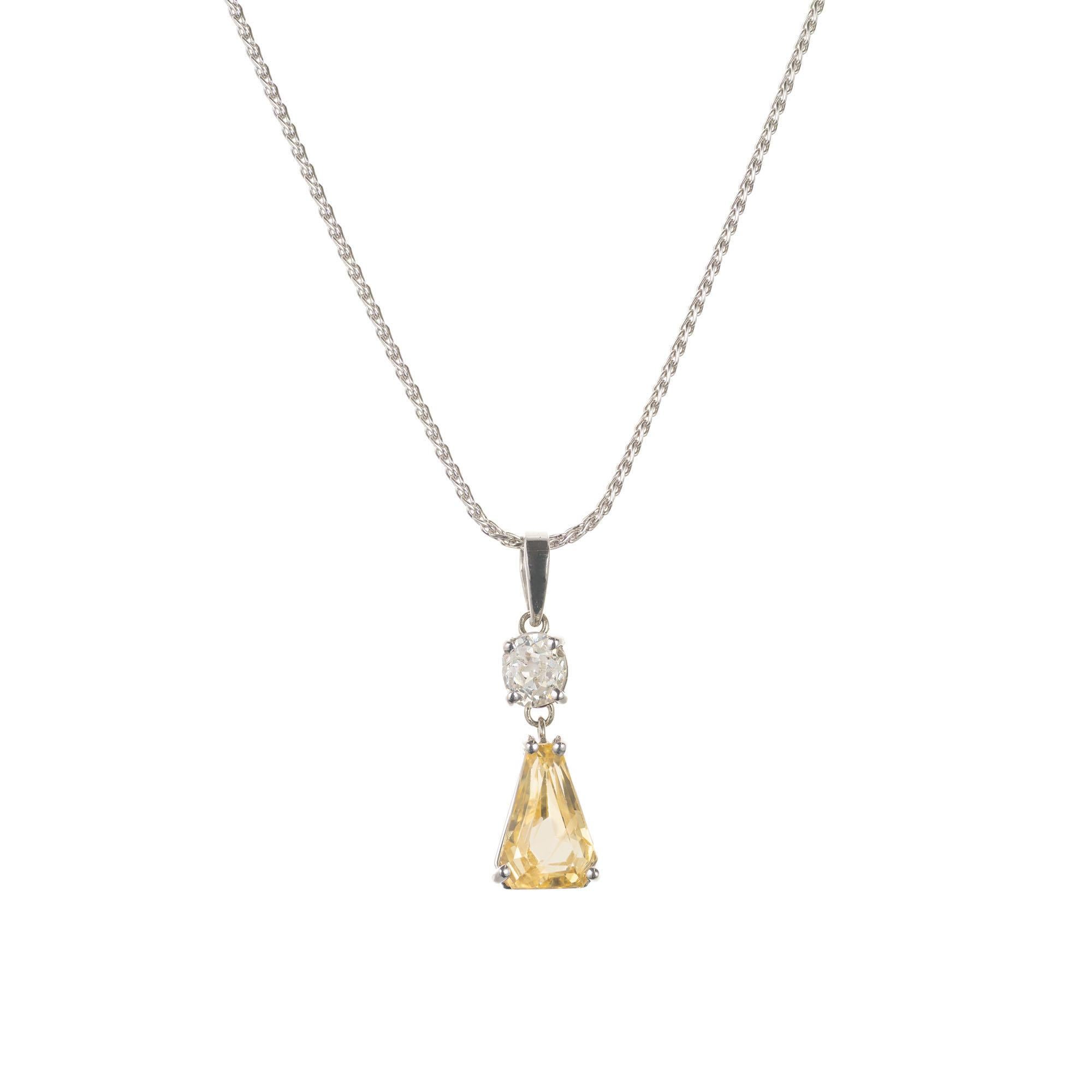 Peter Suchy natural yellow sapphire and diamond pendant necklace. Handmade platinum setting with a  GIA certified shield cut lemon yellow natural sapphire accented by an old mine cut accent diamond. 

1 shield cut yellow sapphire, Approximate total