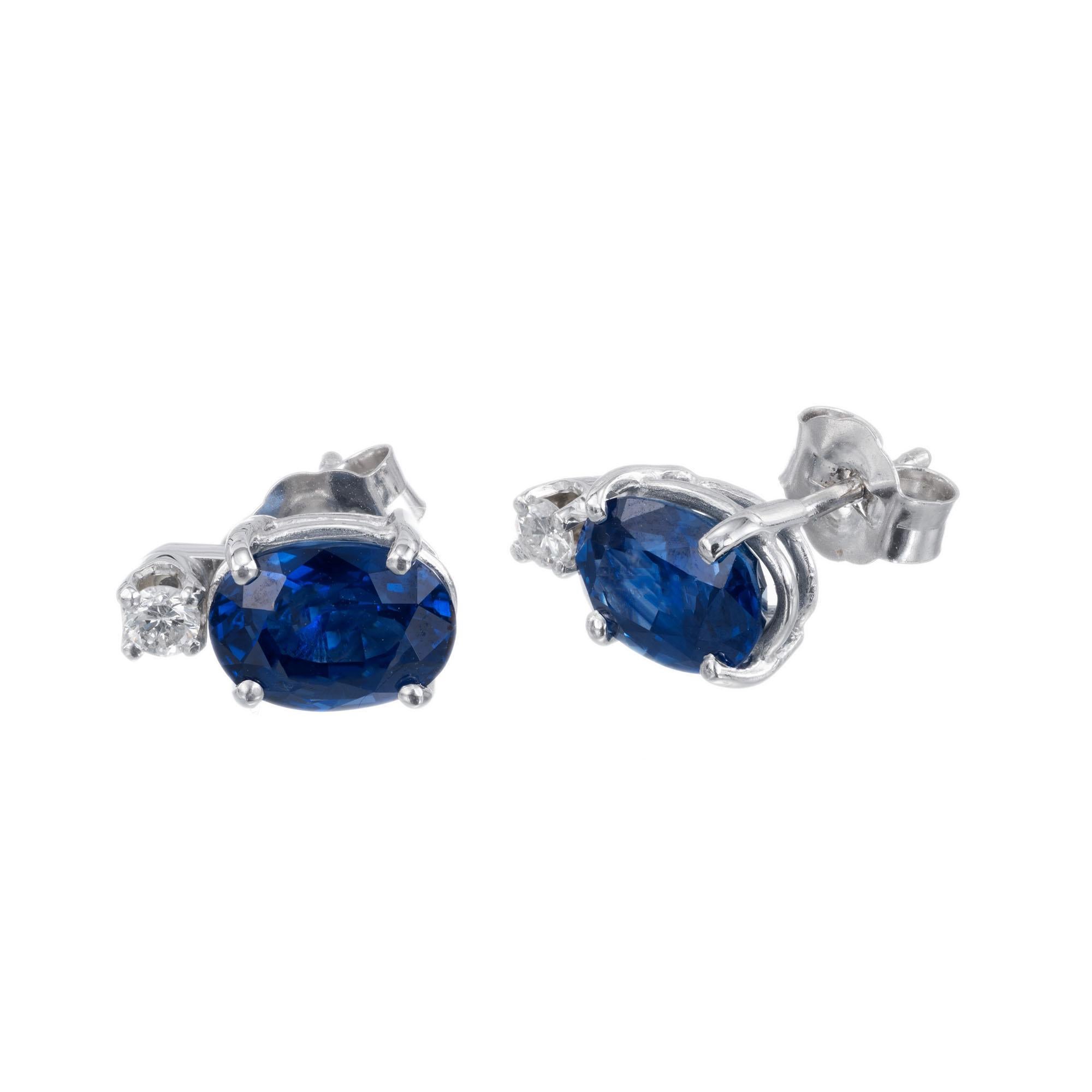 Blue oval sapphires 2.62 carat total GIA certified natural sapphire simple heat only set in a simple 14k white gold diamond earrings in the Peter Suchy workshop 

2 round brilliant cut diamonds G SI, approx. .9ct
1 oval cut blue sapphire MI, approx.