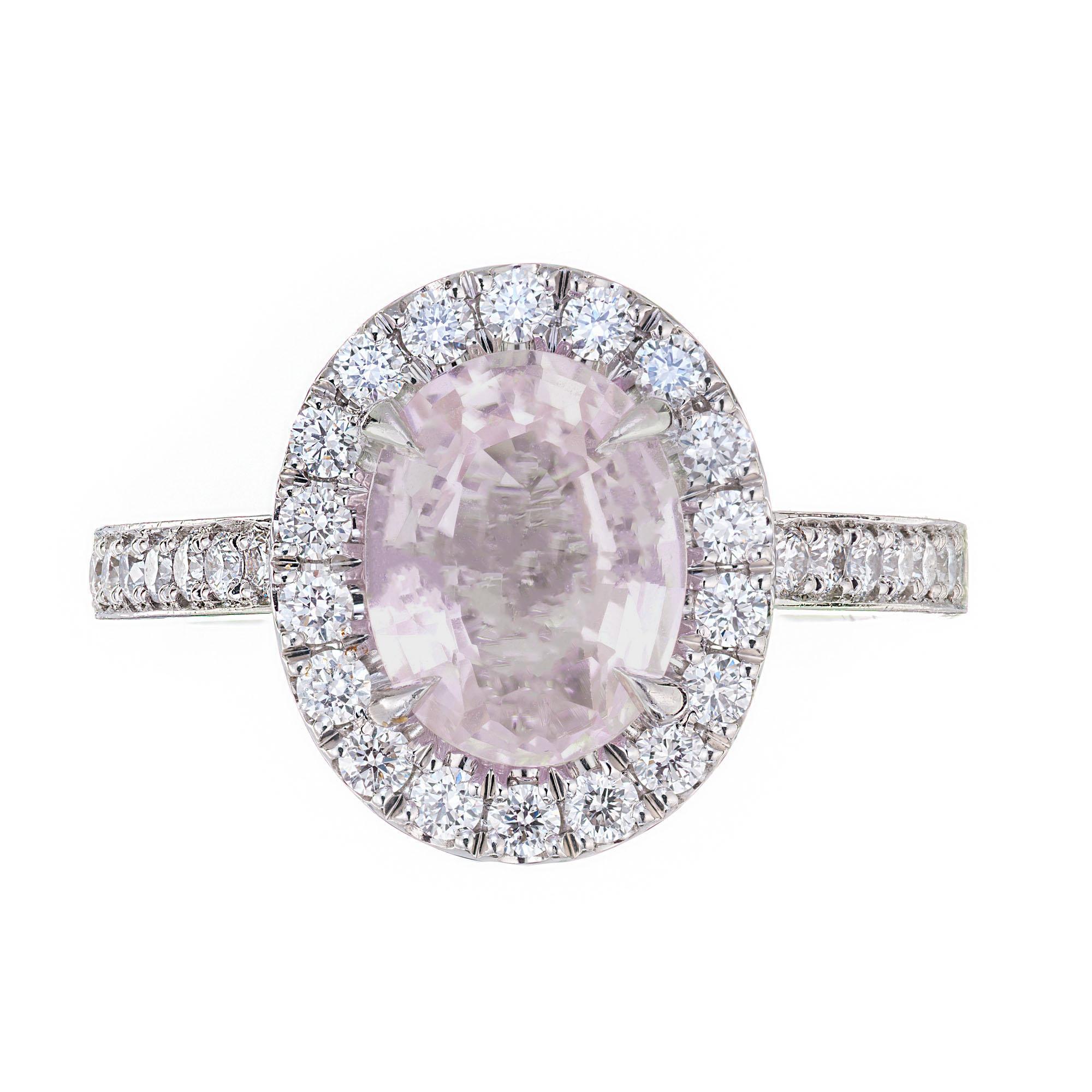 Pink sapphire and diamond halo engagement ring. GIA certified natural no heat very light purplish pink Sapphire with a halo of round cut diamonds in a platinum setting with round cut accent diamonds along the shank.  The Sapphire is from a 1900’s