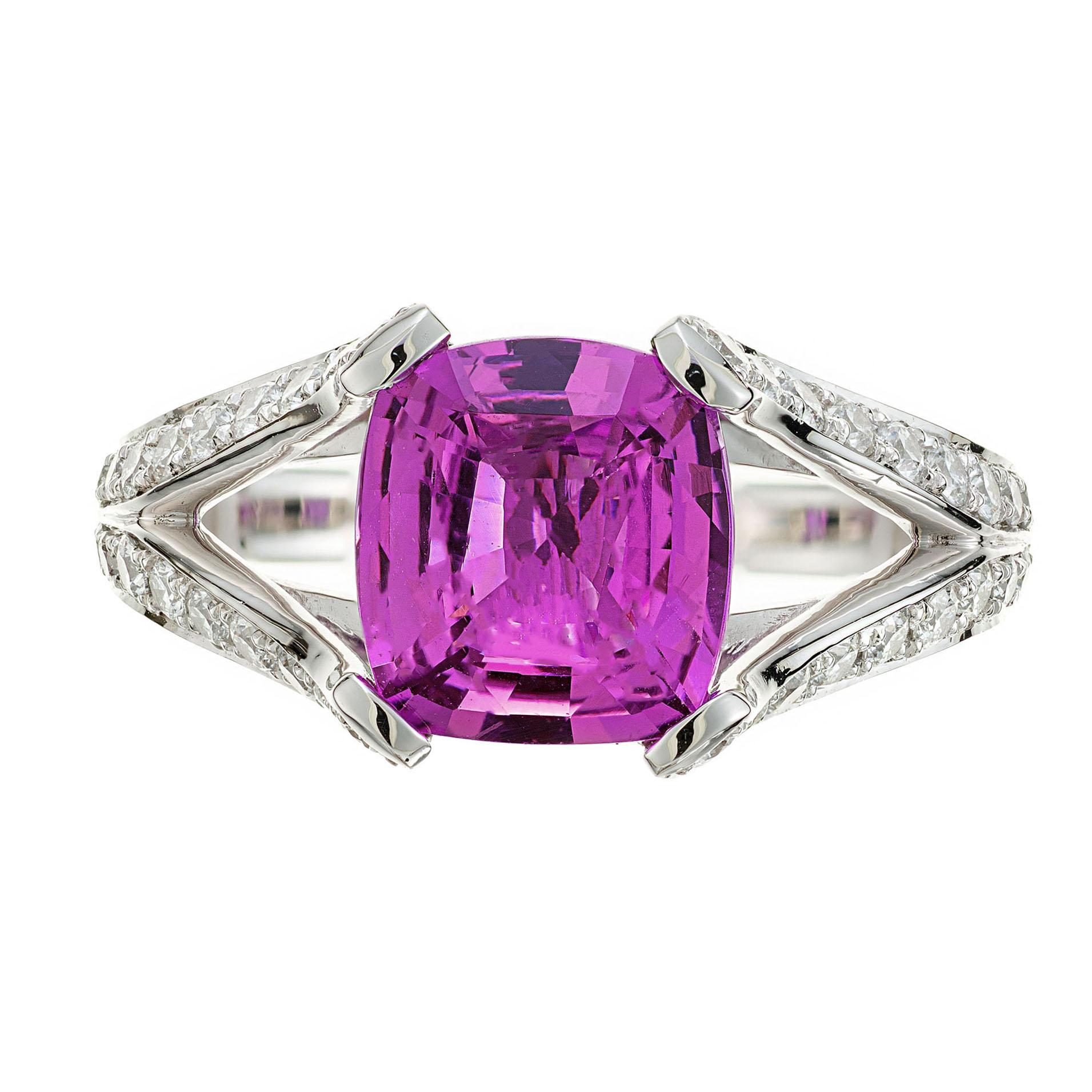 Pink sapphire and diamond engagement ring. GIA certified cushion cut center sapphire in a platinum split shank setting. 54 round brilliant cut accent diamonds. Simply put, this is one of the finest natural purple pink sapphires we have ever seen.