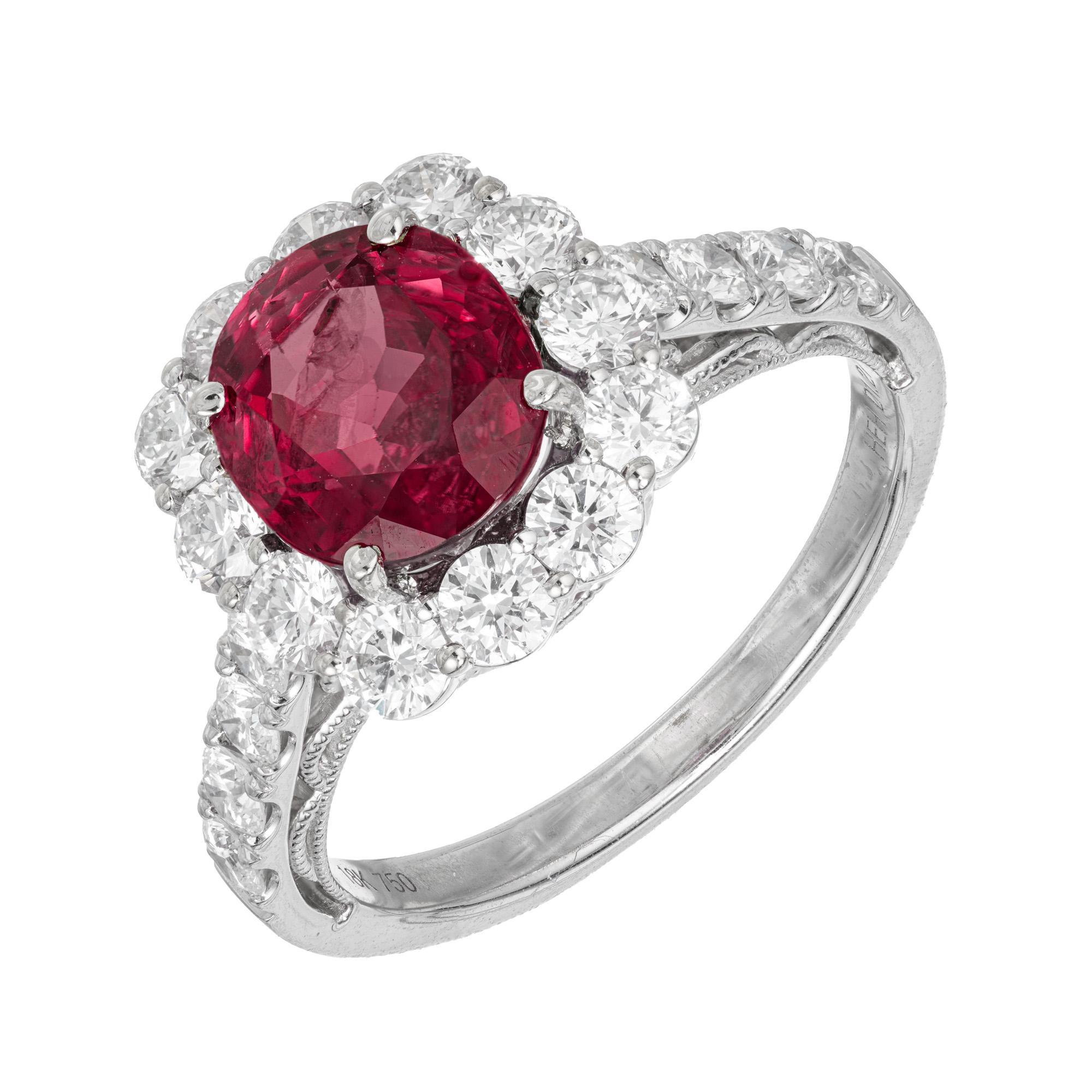 Purple red ruby and diamond engagement ring. 1935-1940's GIA certified oval 2.76cts ruby set in a 18k white gold diamond halo setting with accent diamonds along the shanks. The ring was designed and crafted in the Peter Suchy workshop

1 oval purple