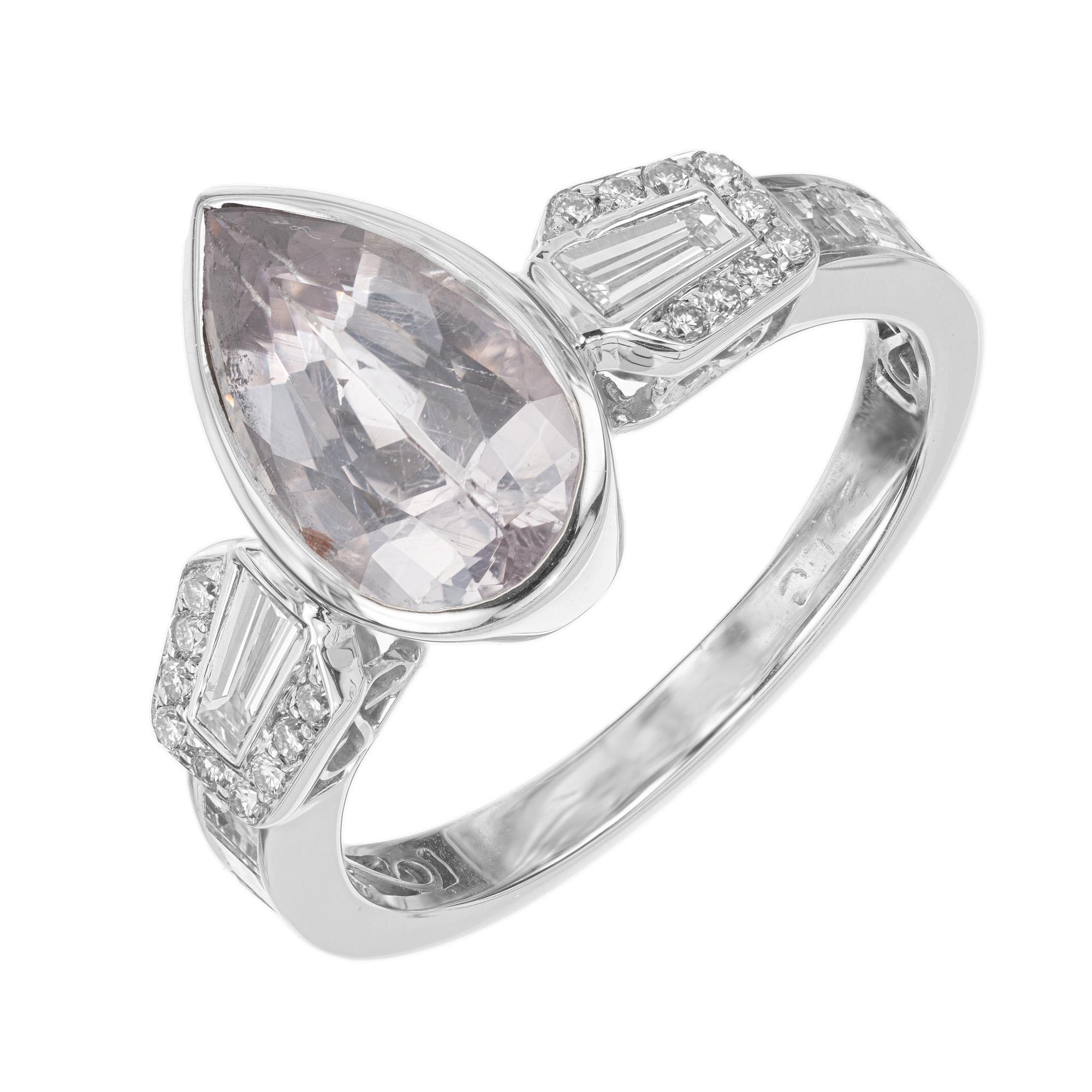A timeless masterpiece that captures the elegance of this 2.91ct pear shaped pink sapphire. Bezel set and mounted mounted in a setting created out of 18k white gold which is accented with two tapered baguette diamonds on each side with each having a