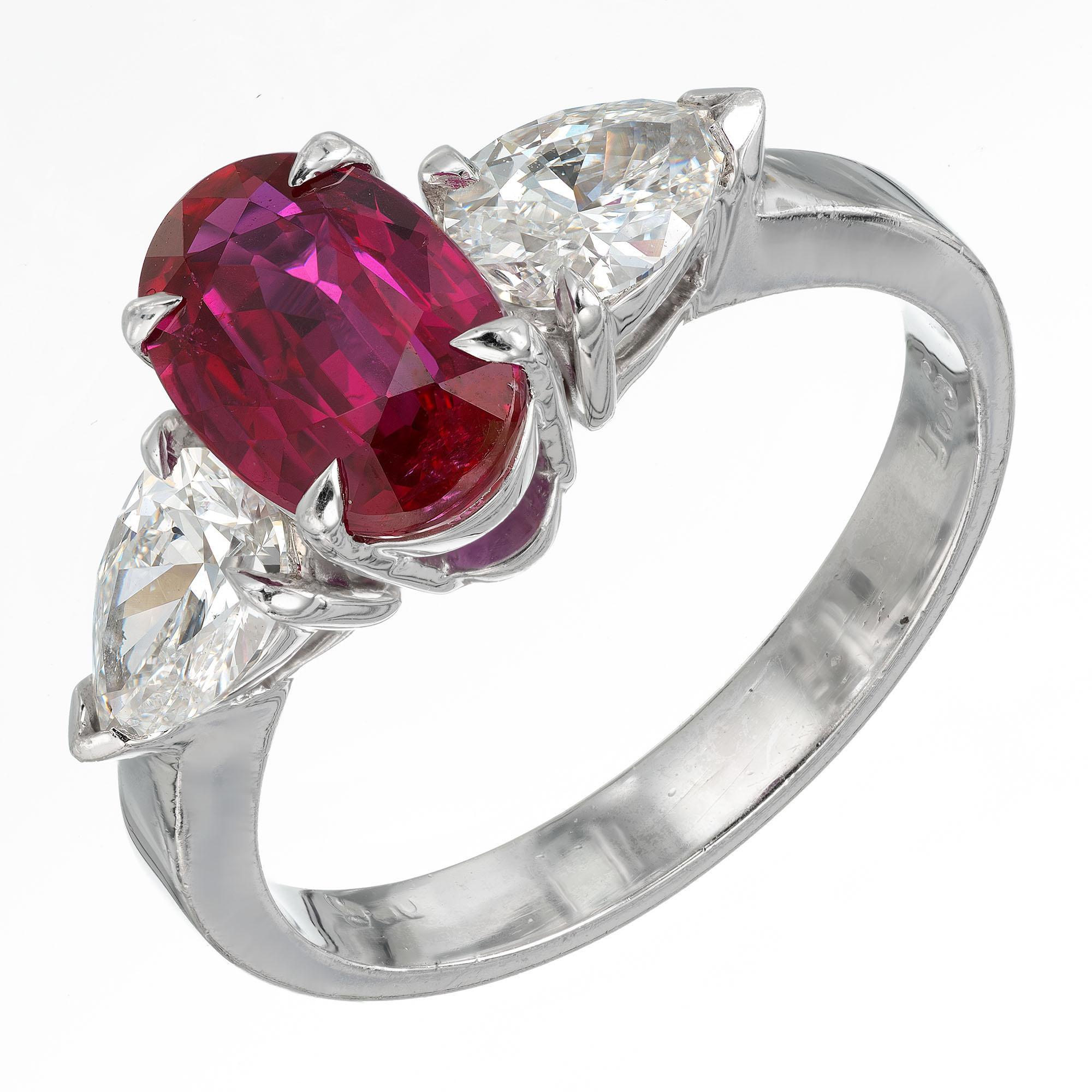Three-stone oval ruby center stone with two pear shaped diamond side accents. The platinum setting is handmade from the Peter Suchy Workshop. GIA certified. 

1 oval natural rare purplish red Ruby, approx. total weight 2.02cts, SI1, 9.11 x 6.07 x
