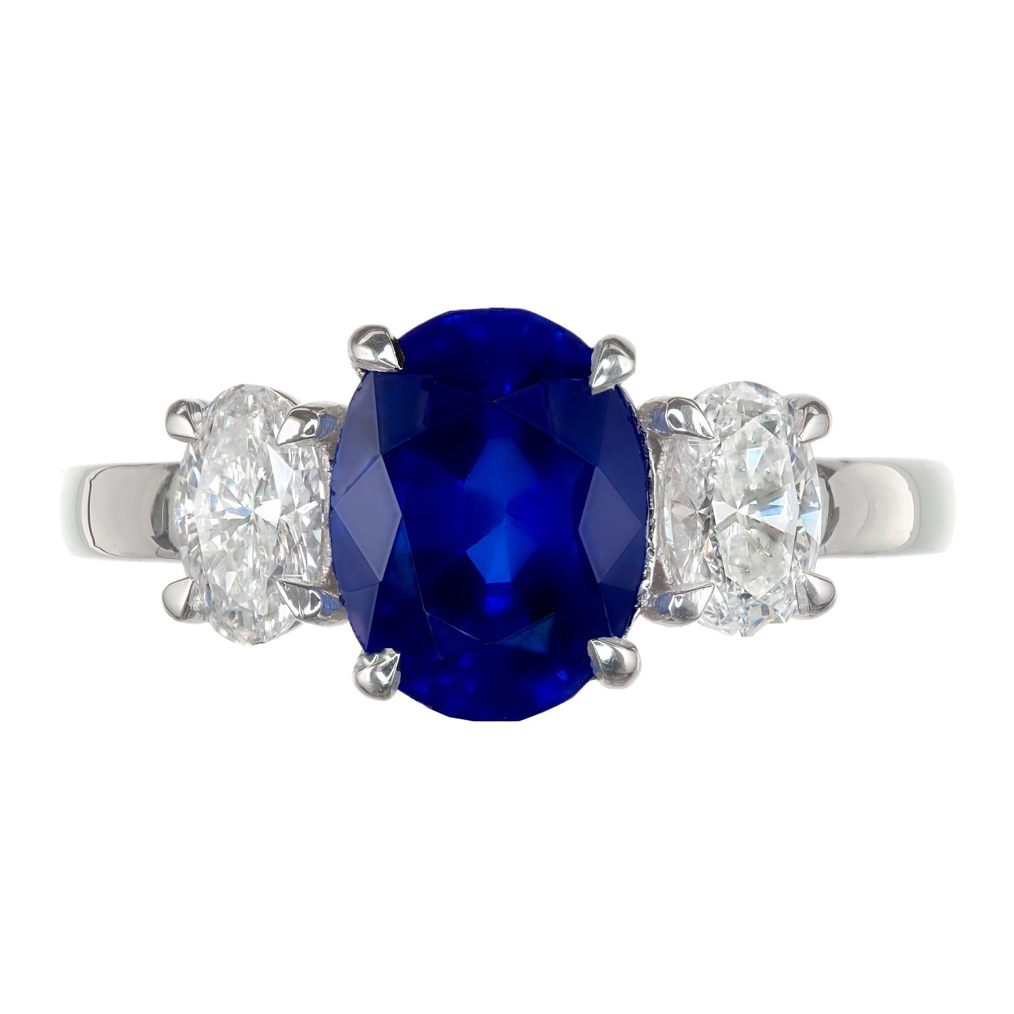 Oval blue sapphire and diamond three-stone engagement ring. GIA Certified center stone is from a 1940's estate. Platinum setting with two oval accent diamonds. The setting was designed in the Peter Suchy Workshop.

1 oval brilliant cut blue SI