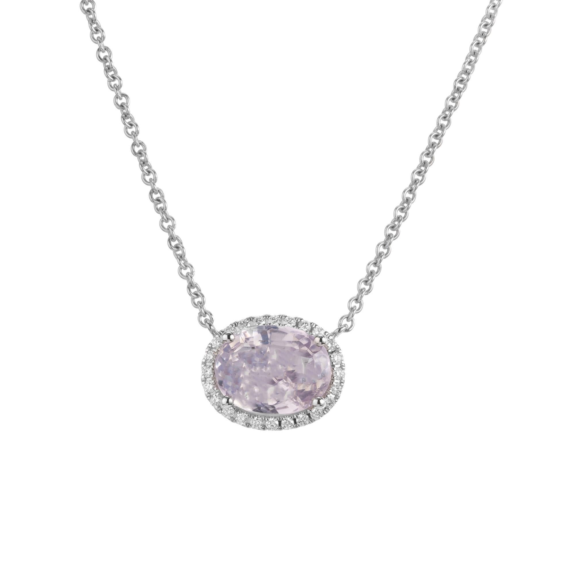 Natural untreated pink sapphire and diamond pendant necklace. The center stone is a 3.45 oval, pink and purple sapphire set horrizontally in a 14k white gold setting with a halo of 24 round brilliant cut diamonds. and surrounded by sparkly full cut
