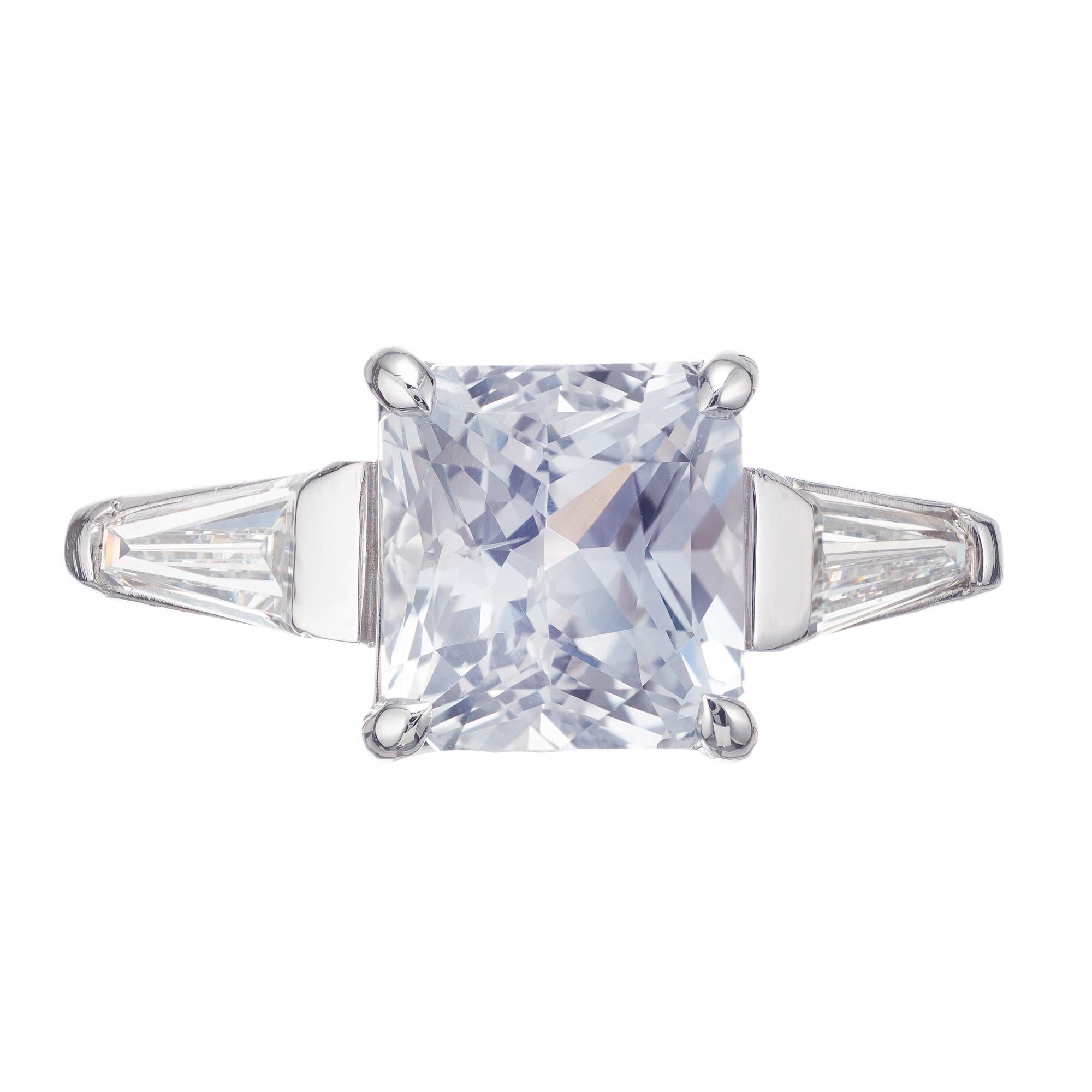 Octagonal sapphire and diamond three-stone engagement ring. The GIA certified center stone is from a 1930's estate. The platinum setting has two tapered baguette side diamonds and was crafted in the Peter Suchy Workshop.

1 octagonal white-near